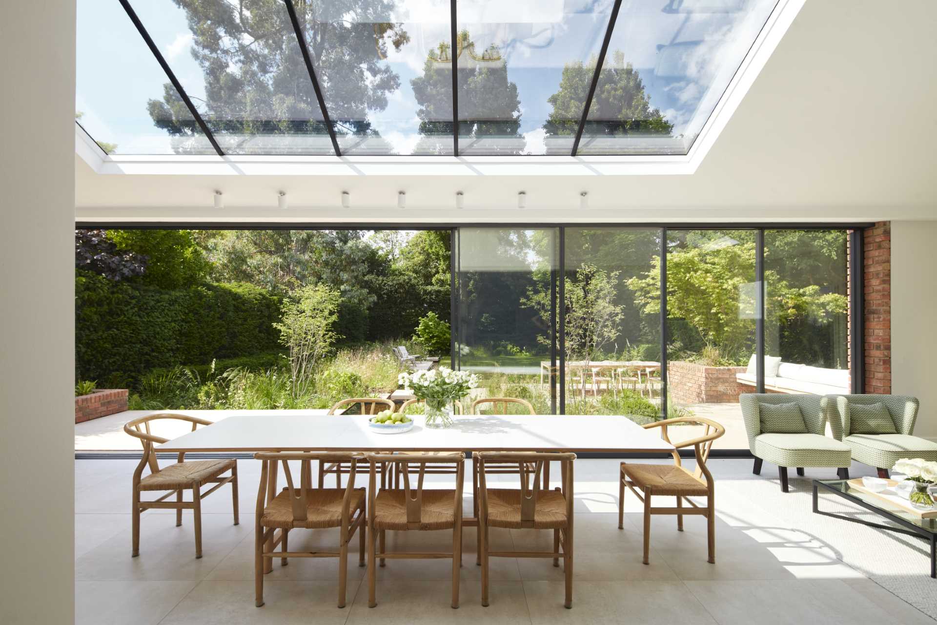 An updated brick extension for an Edwardian home includes a sitting area and dining area for eight people.