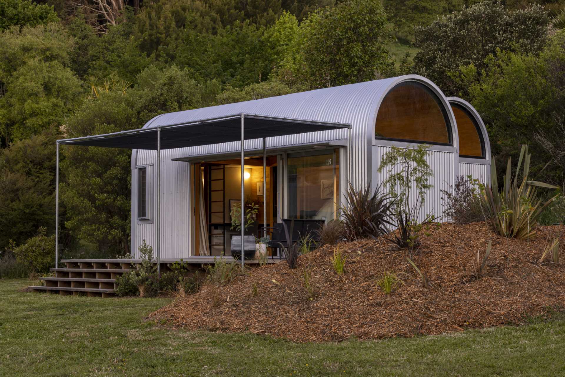 A modern and small one-bedroom home with a study, kitchen, loft, and bedroom.