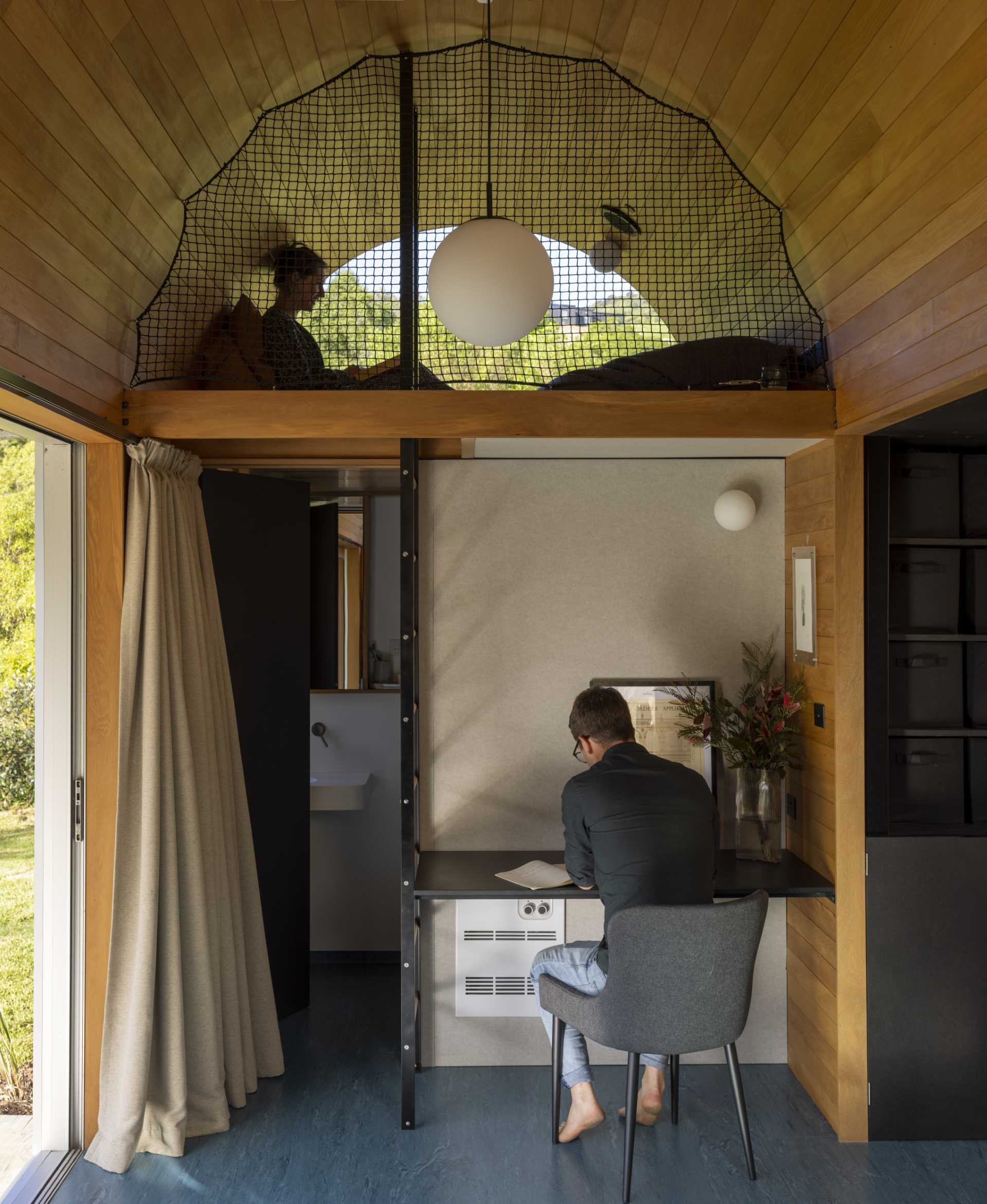 A study and reading loft in a small one-bedroom home.