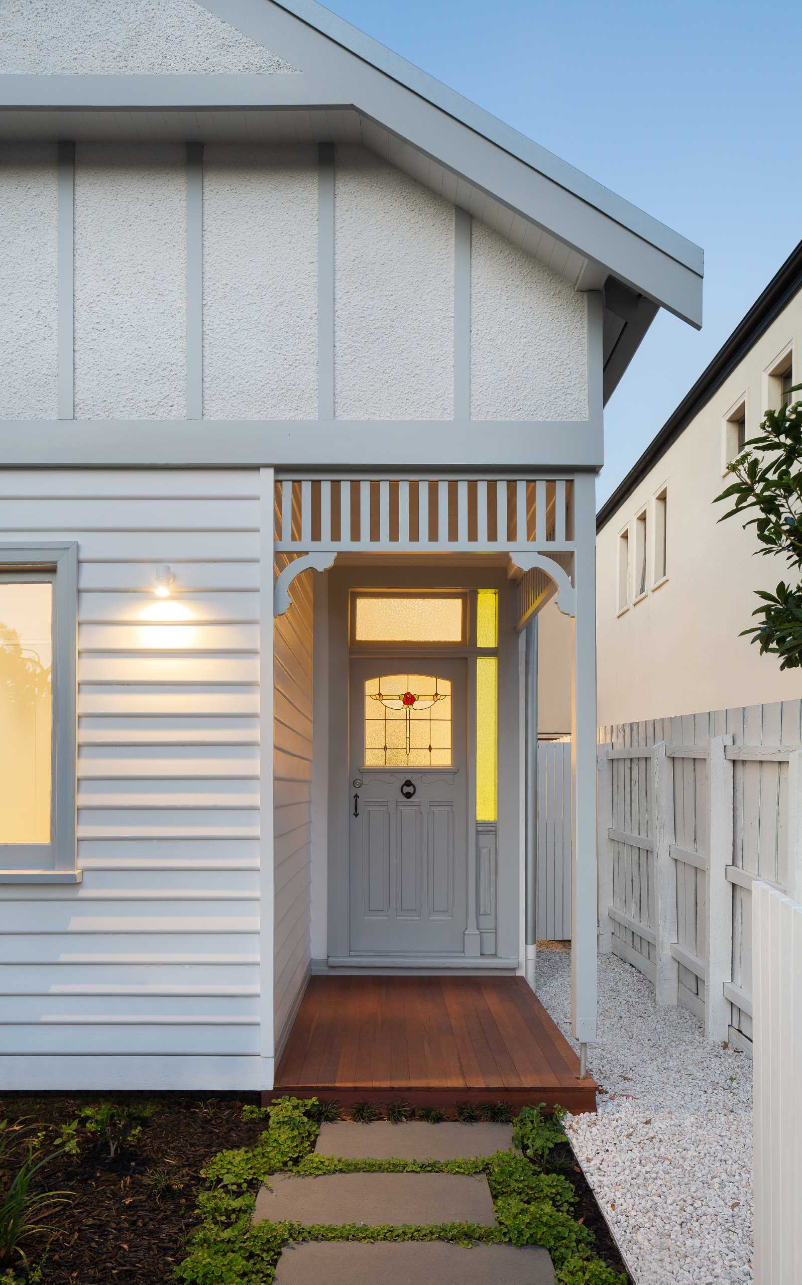 The quaint heritage home fits in with the other homes in the neighborhood, while the new rear extension peaks out from behind.