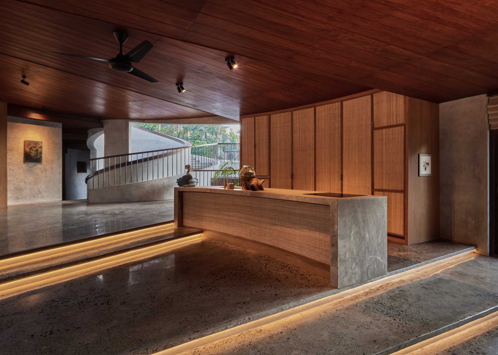 This modern kitchen span across two different steps and follows the curve of the exterior wall.