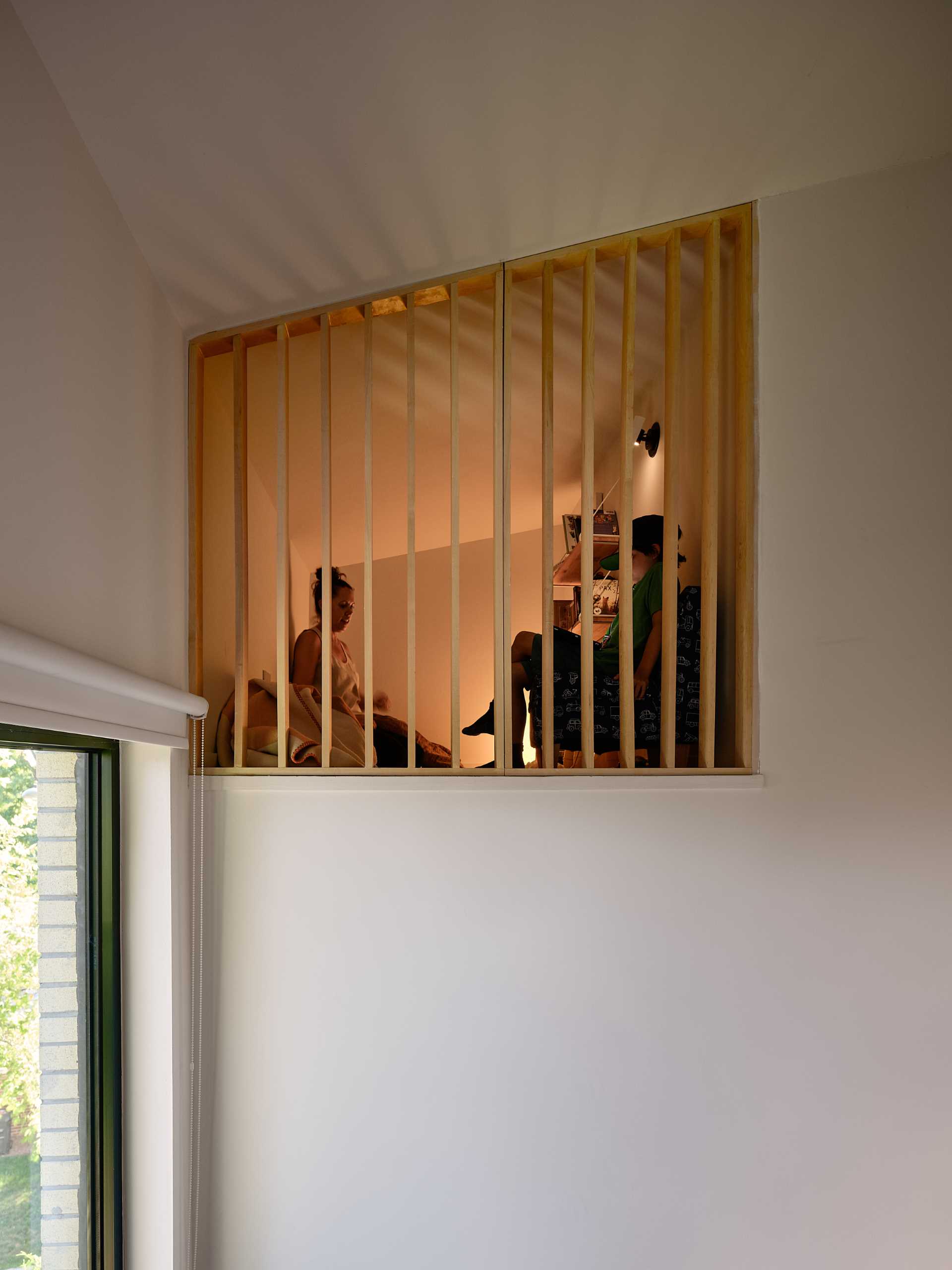 A small reading loft accessed by custom designed ladders.