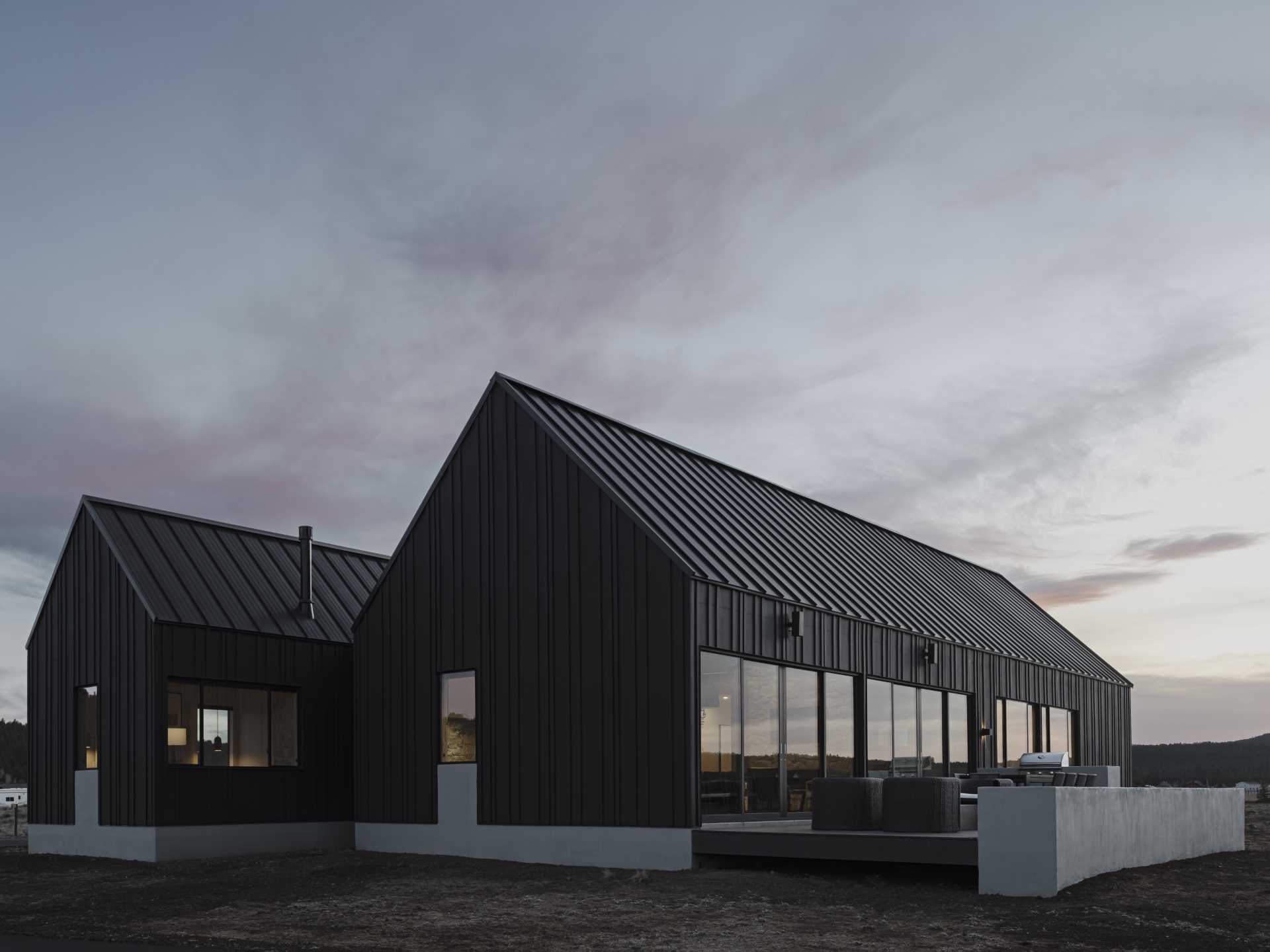 The surrounding landscape is reflected in the decision to choose a black exterior for the home, while the interiors were inspired by the Danish concept of Hygge.