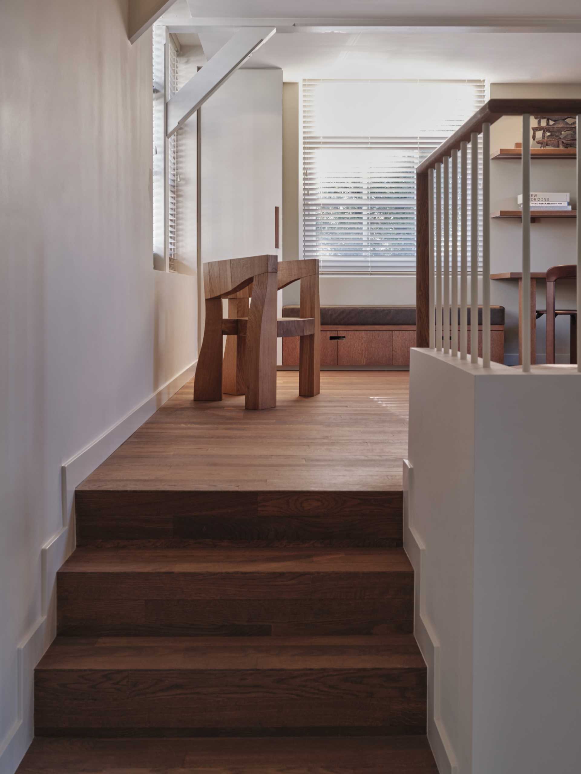 A study on a split-level includes desks, built-in furniture and a fireplace.