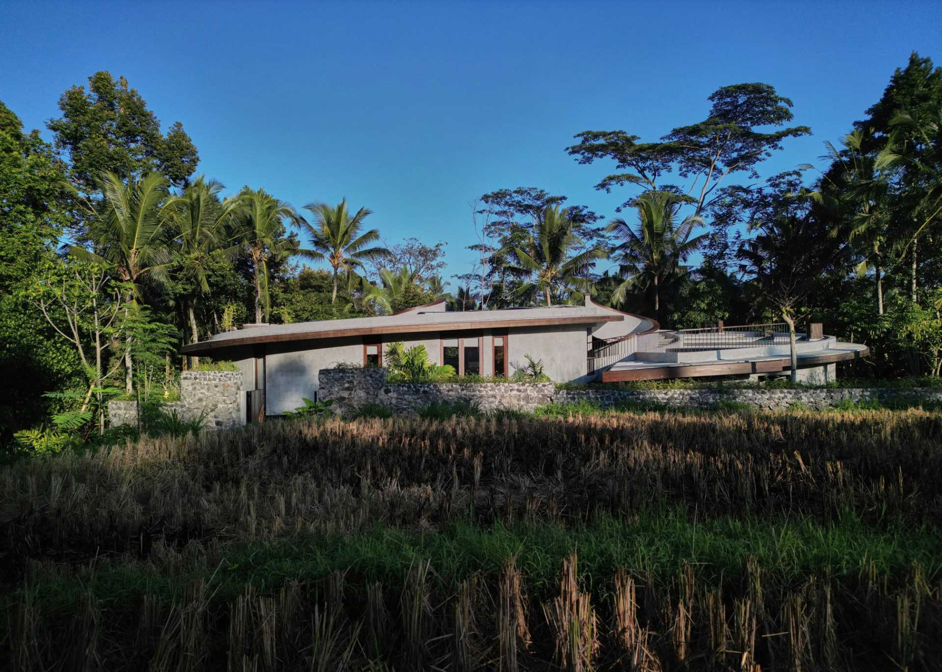 A modern house with a unique design centered around a pair of spiral staircases.