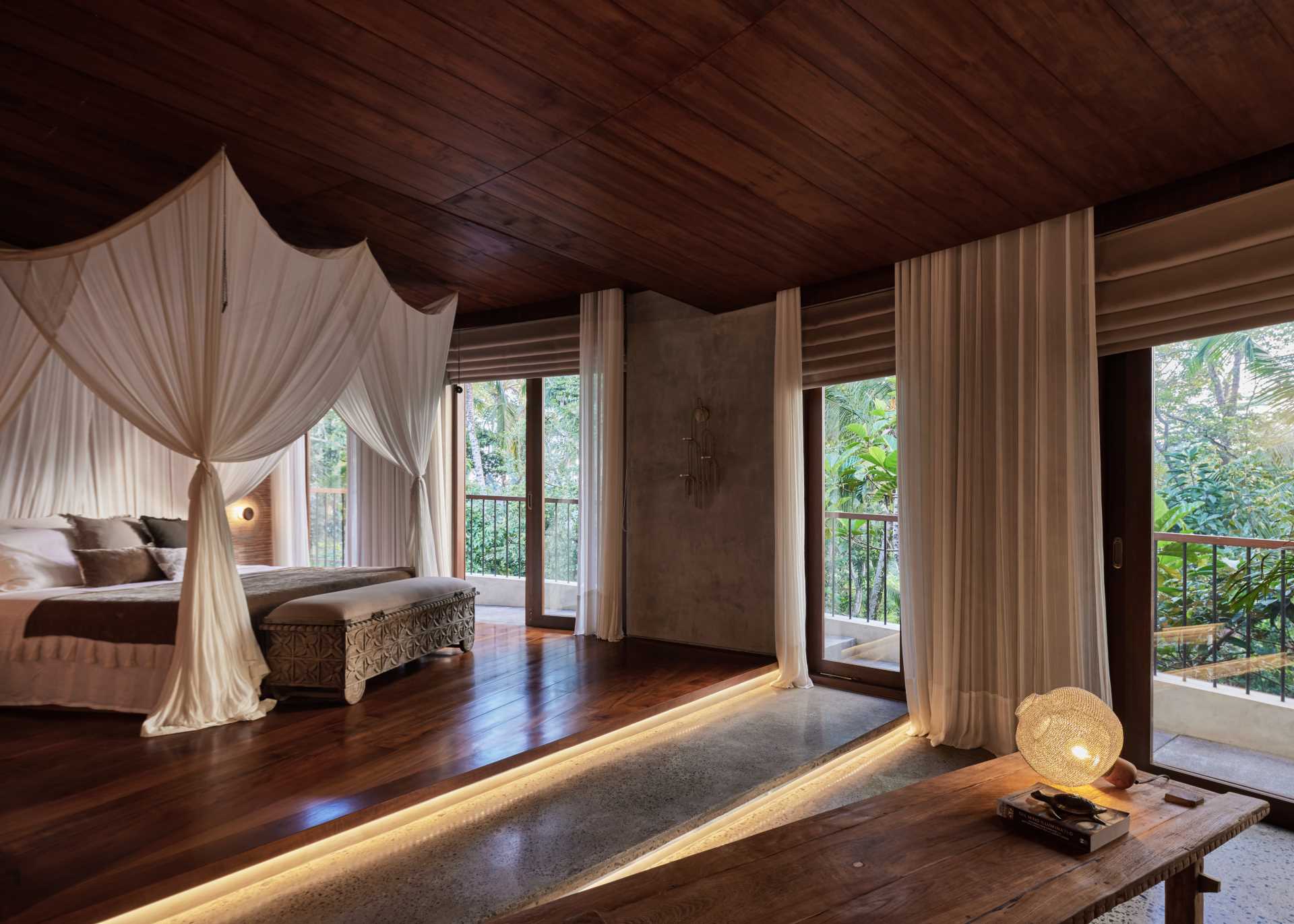 A modern bedroom with hidden lighting underneath the steps.