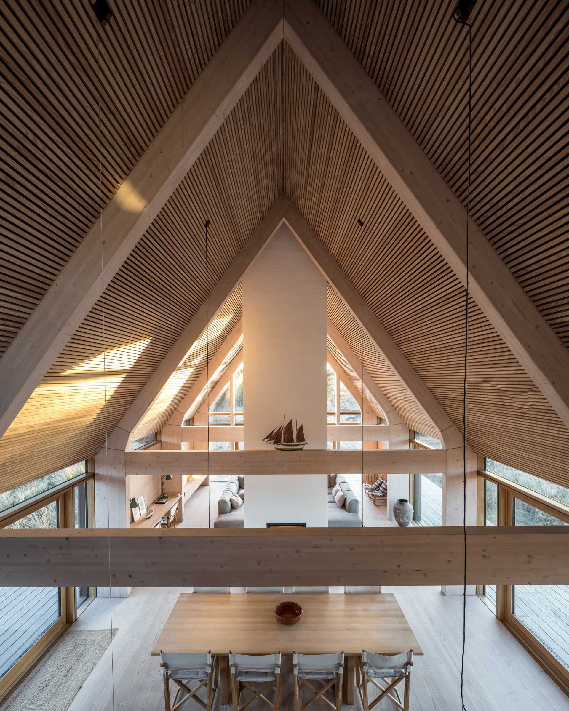 A modern home has a wood-lined roof and structural wood supports made from Douglas Fir.