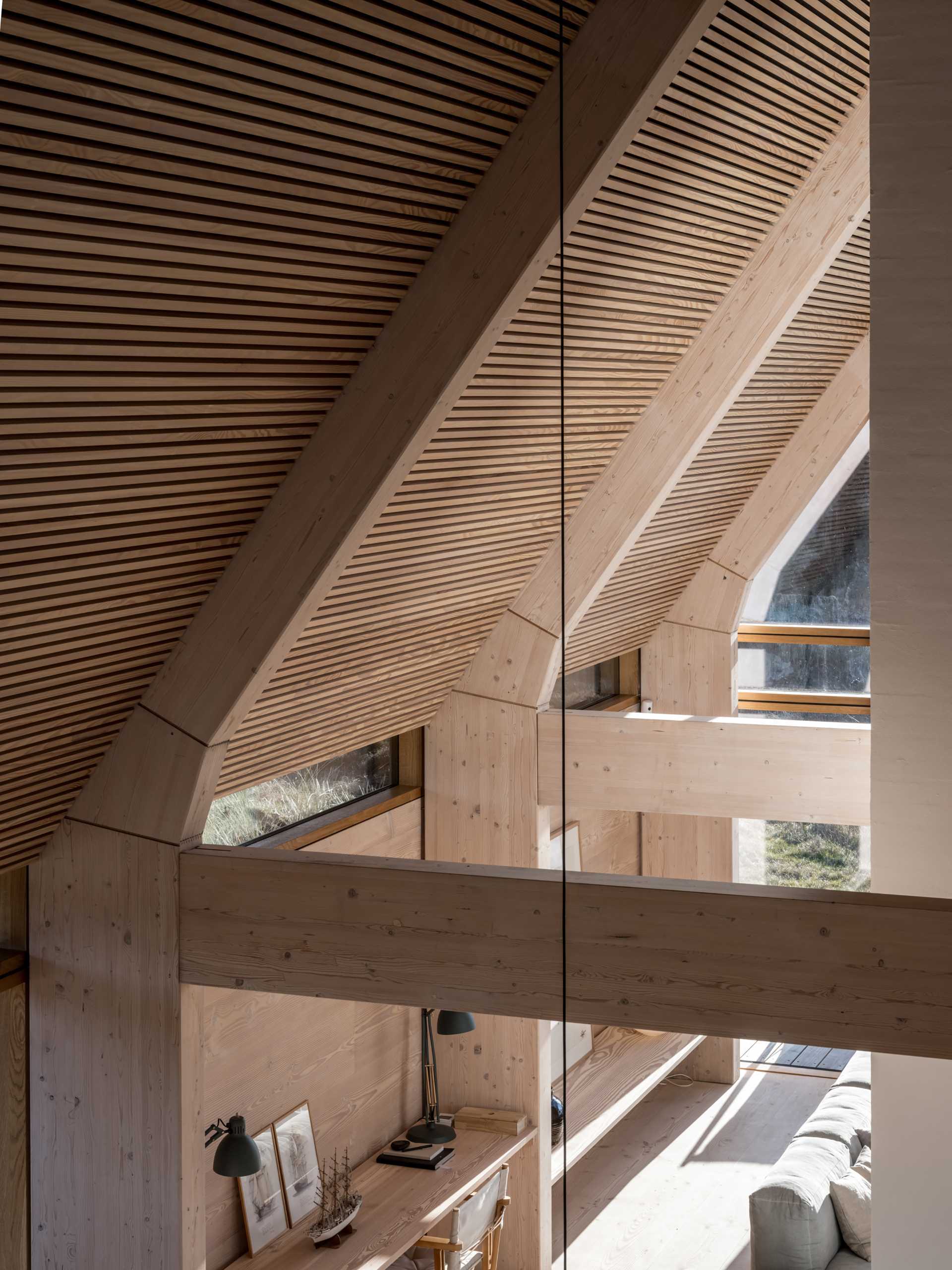 A modern home has a wood-lined roof and structural wood supports made from Douglas Fir.