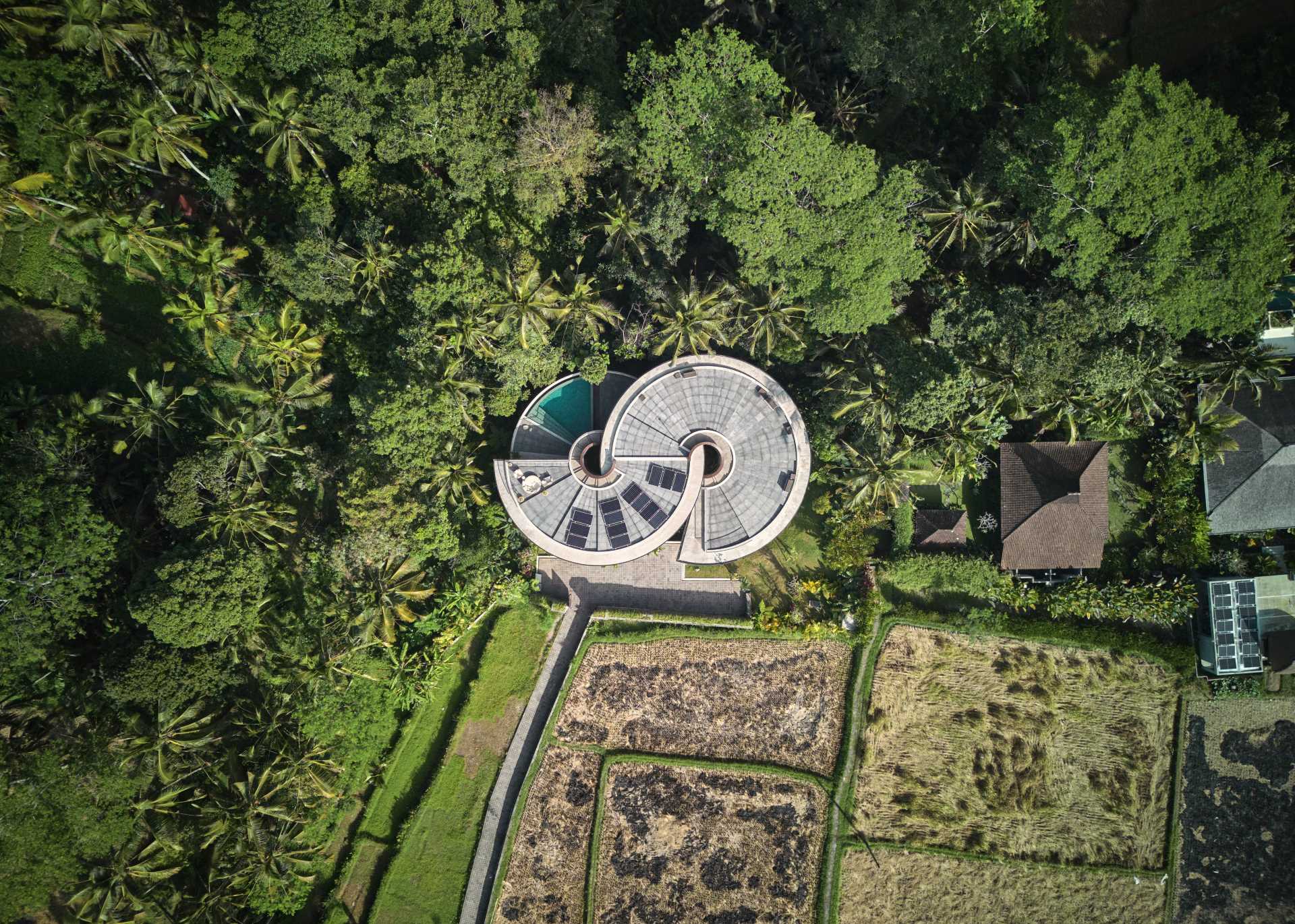 A modern house with a unique design centered around a pair of spiral staircases.