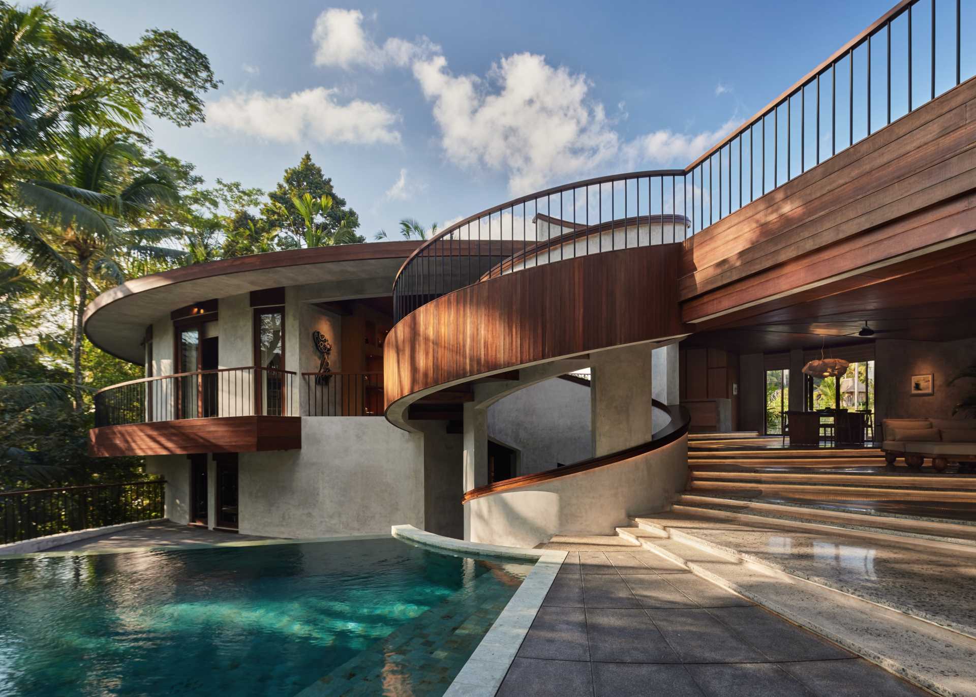 A modern house with a unique design centered around a pair of spiral staircases.