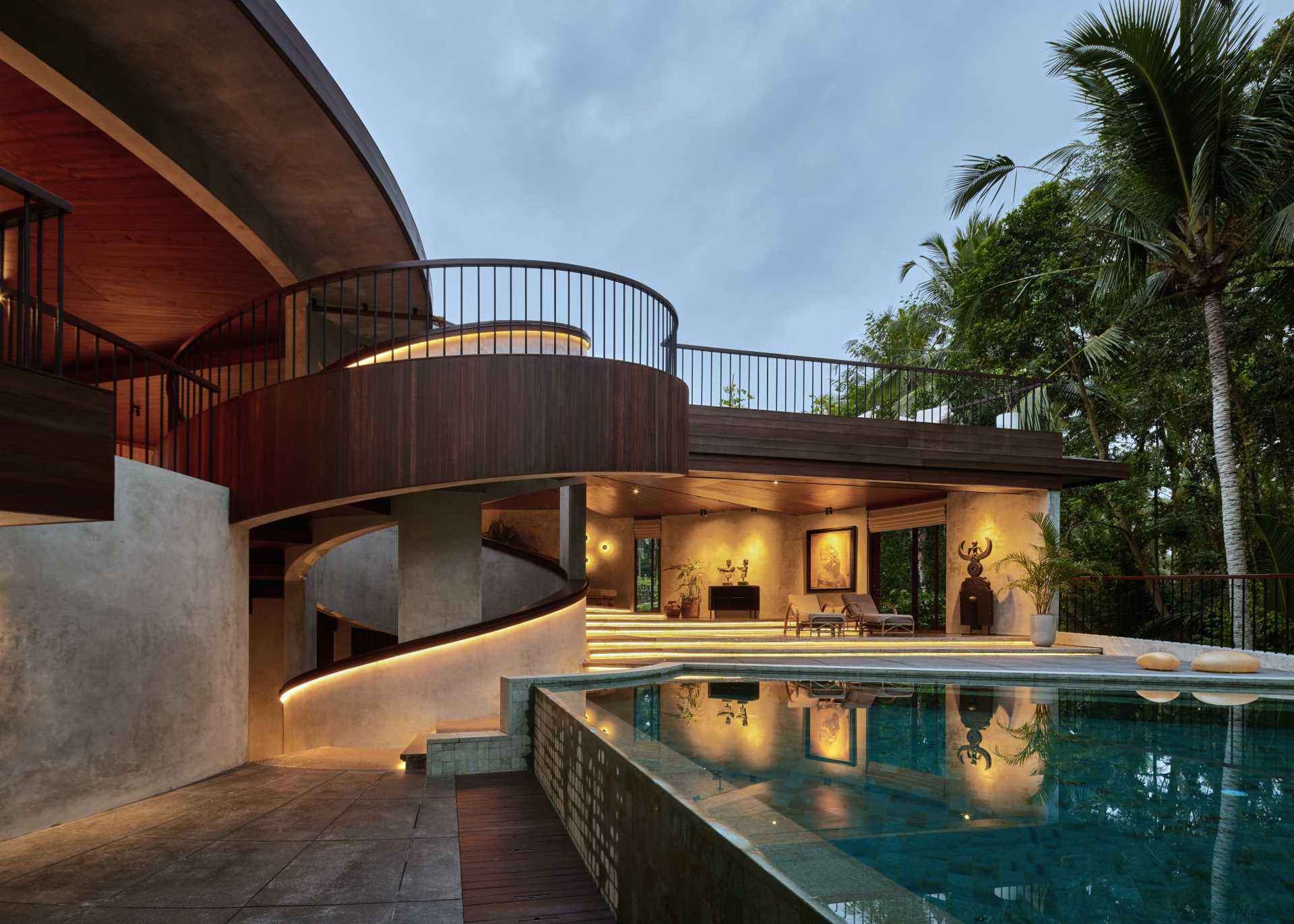 Hidden lighting showcases the design of the stairs and the spiral handrail, which can be seen throughout the home.