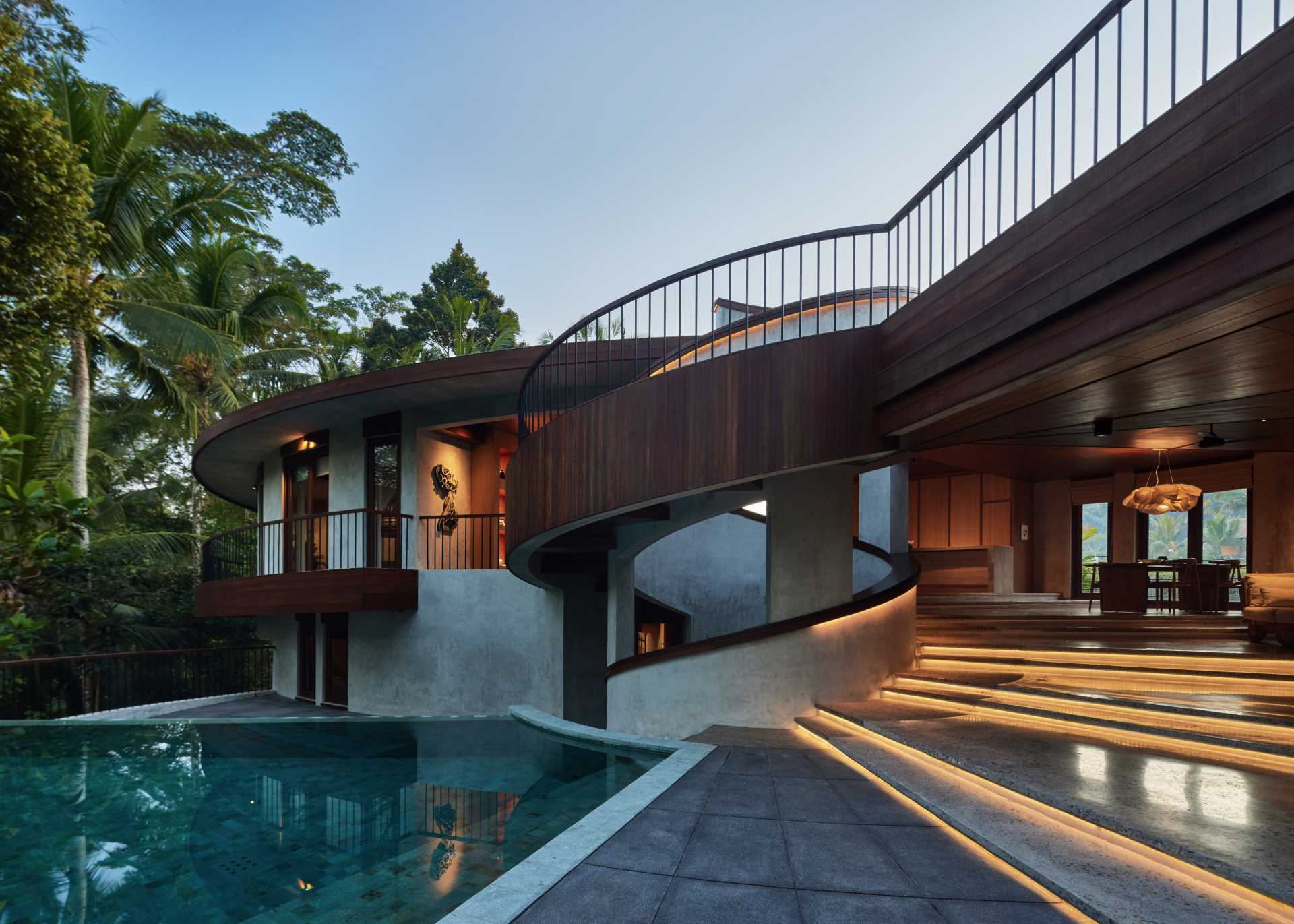 Hidden lighting showcases the design of the stairs and the spiral handrail, which can be seen throughout the home.