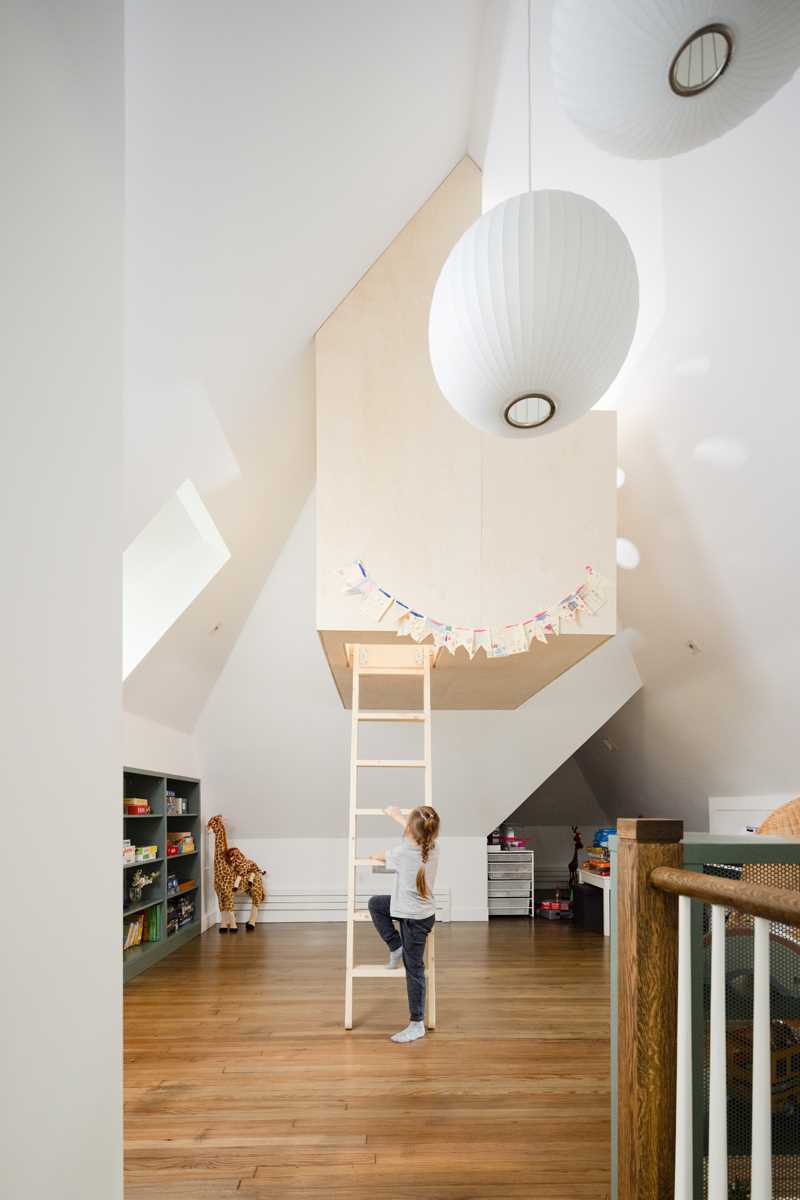 A modern playroom with a custom-built treehouse.