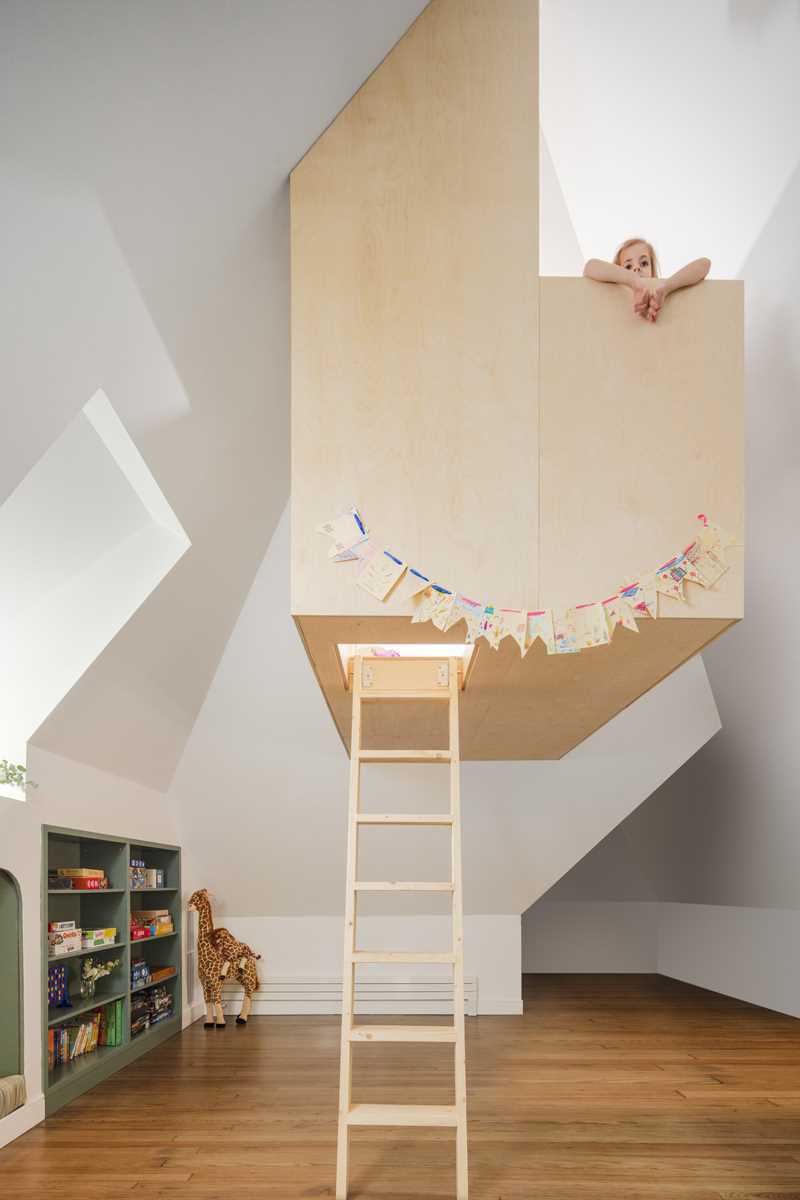 A modern playroom with a custom-built treehouse.