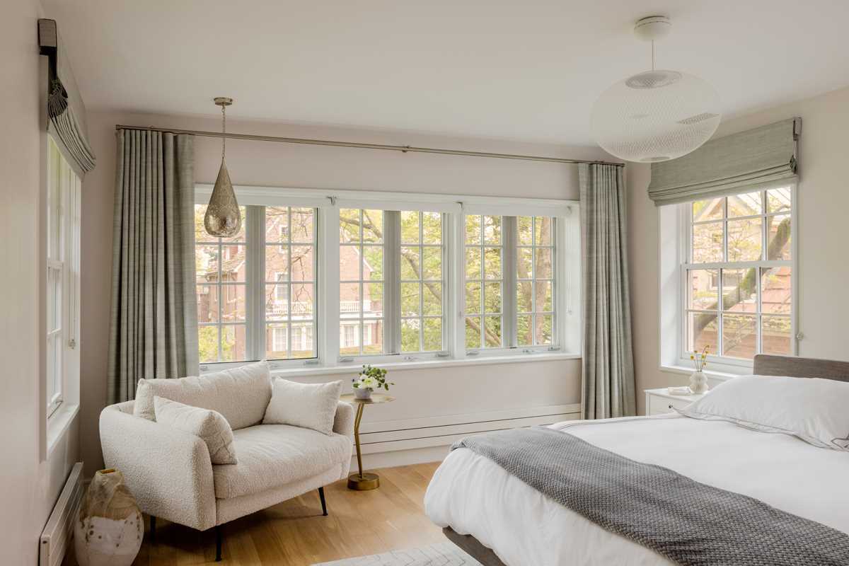 A bedroom with windows on three sides.