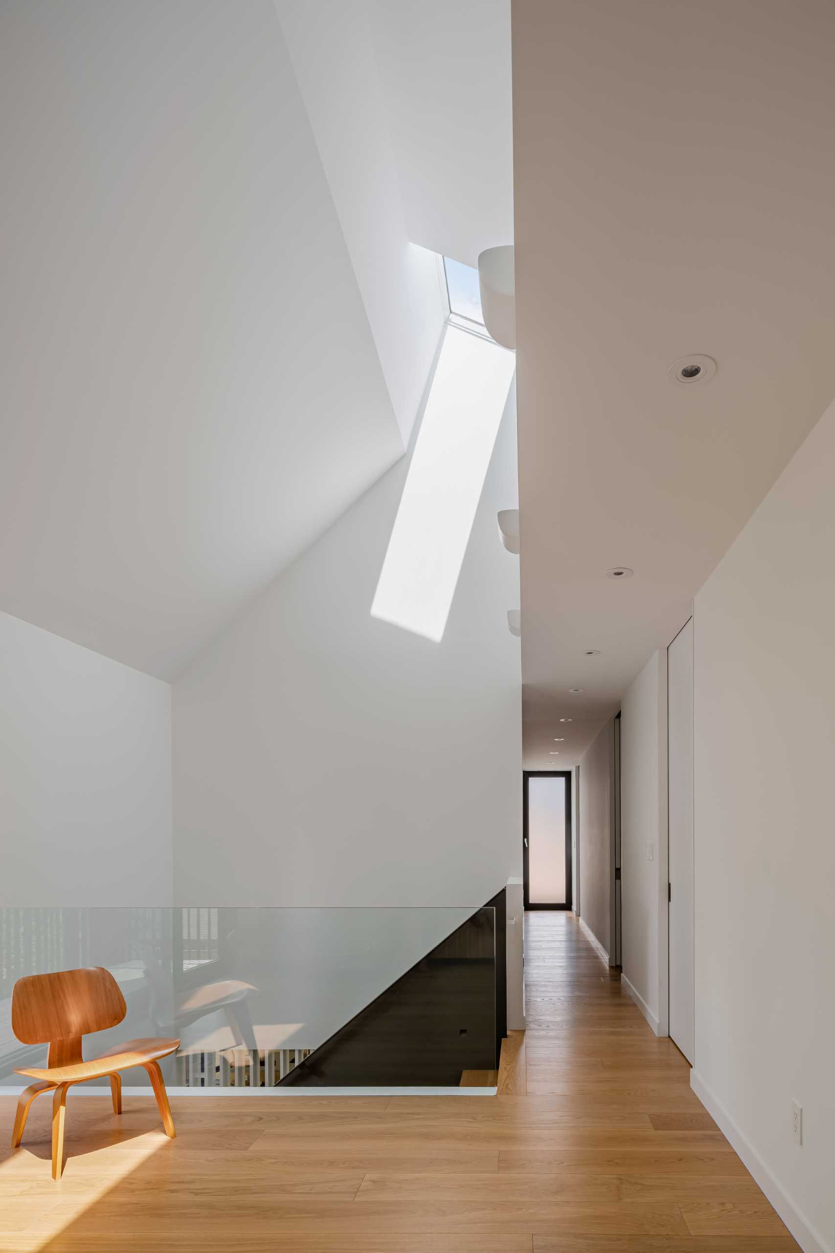 A modern home with a skylight at the top of the stairs.
