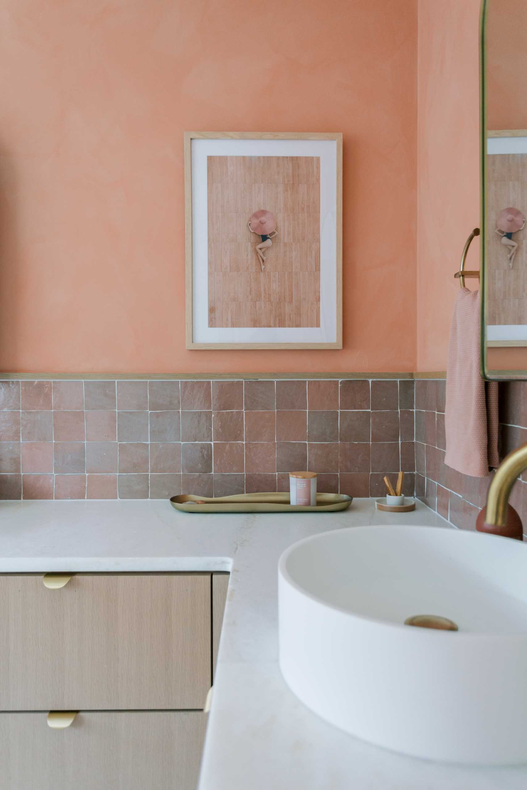 A contemporary bathroom renovation received a new corner vanity with double sinks, new tiles, and colorful walls.