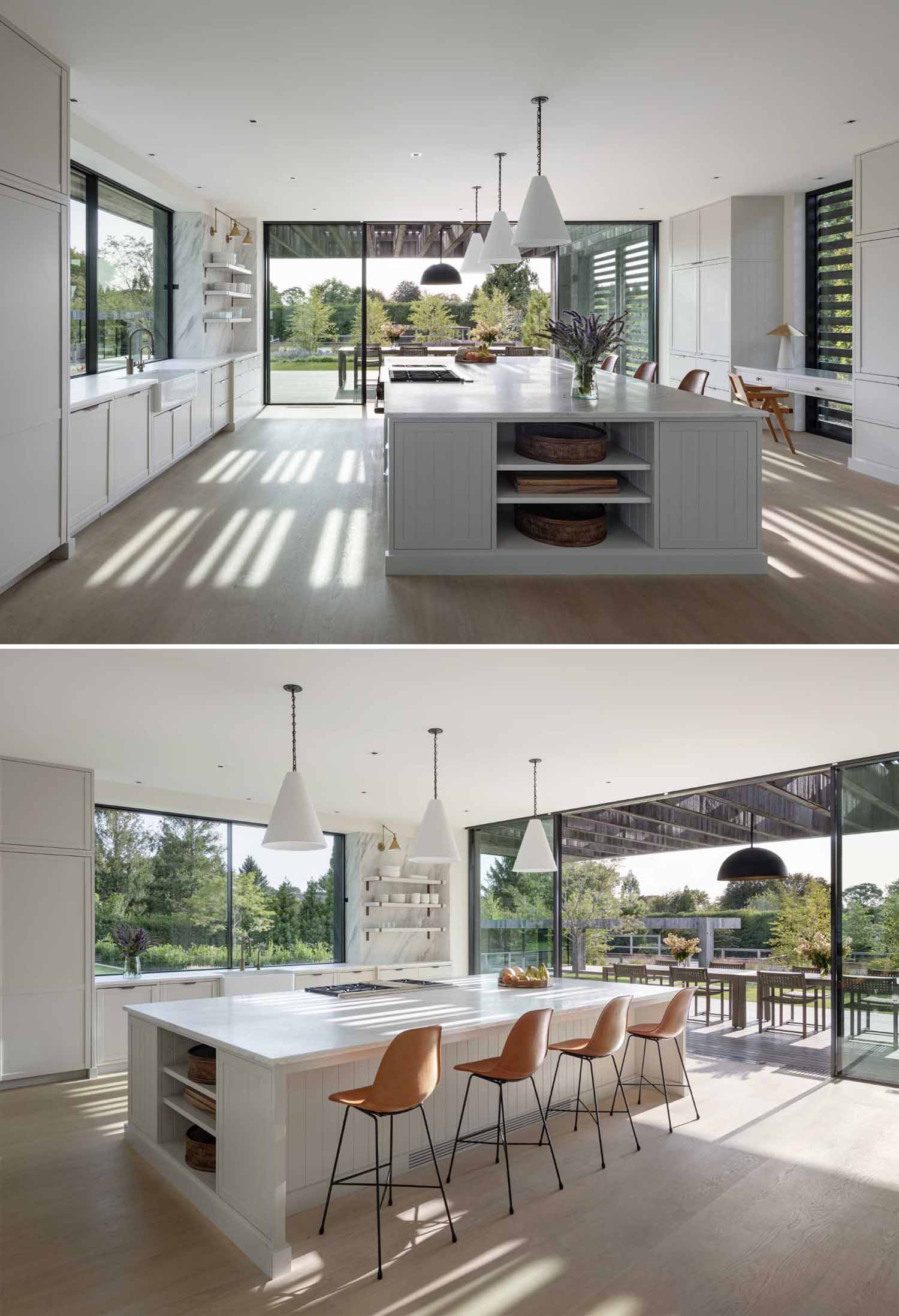 The kitchen has a large island with seating and storage, while the nearby sliding glass doors open to the porch for outdoor dining.