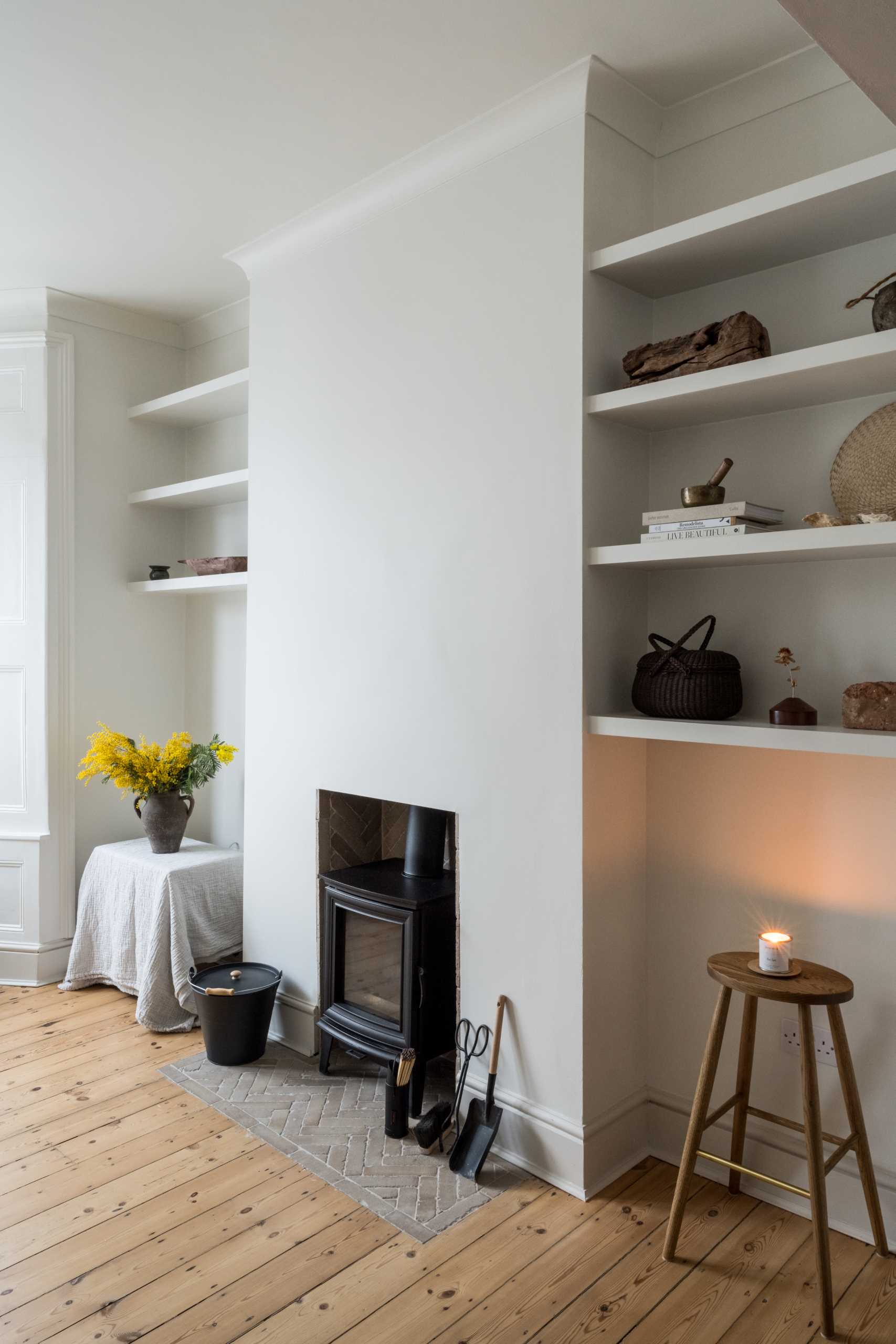 A renovated living room retained original elements, like the fireplace.