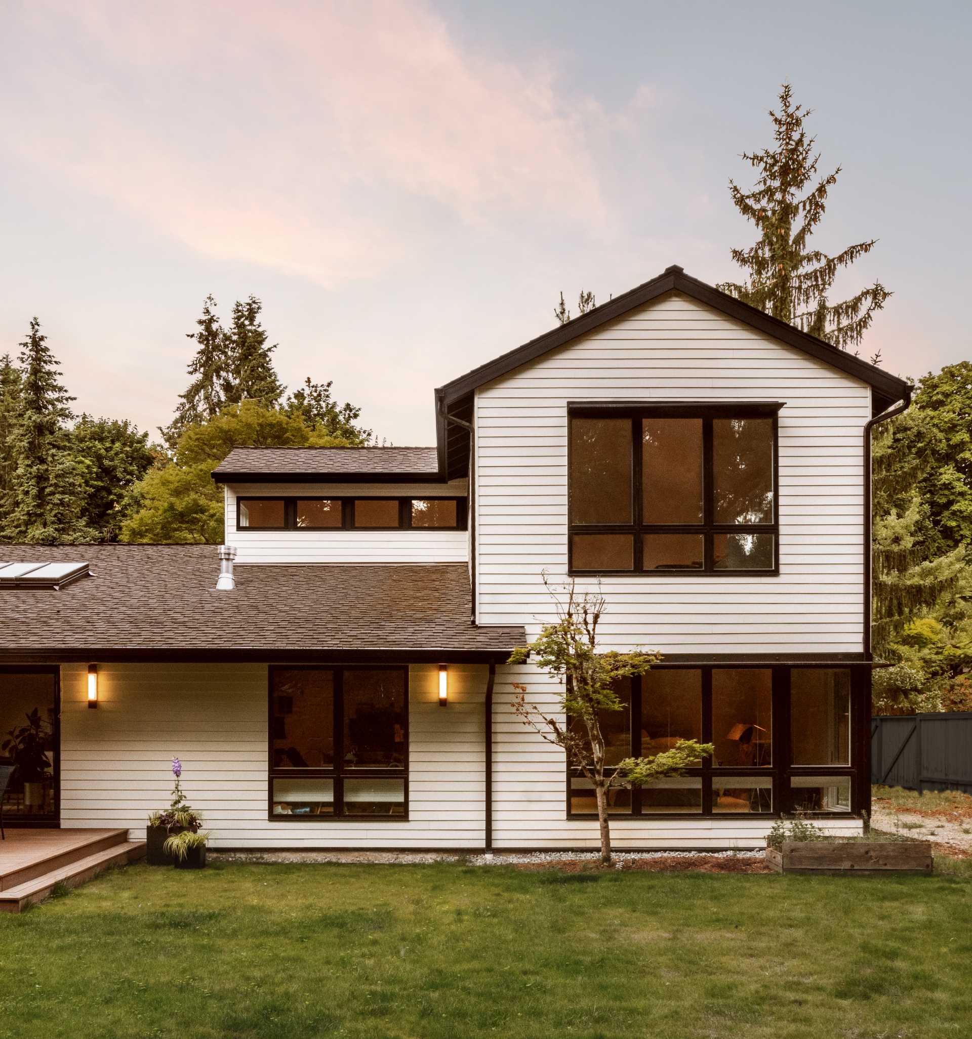 The updated rear of the home includes a warm wood deck, a fire pit area, and a "pop top" addition.