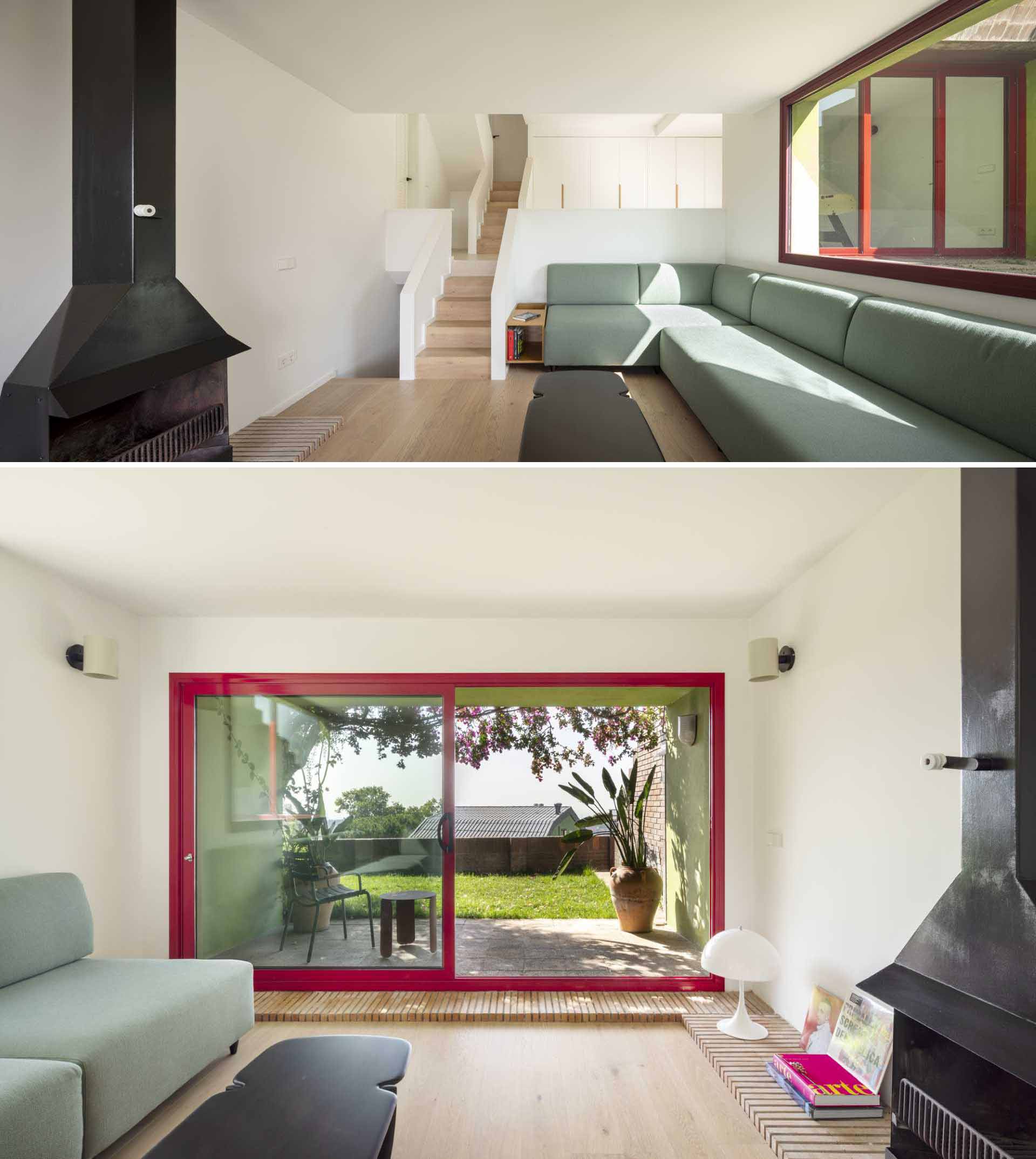 A contemporary family room with a green couch and a black fireplace.