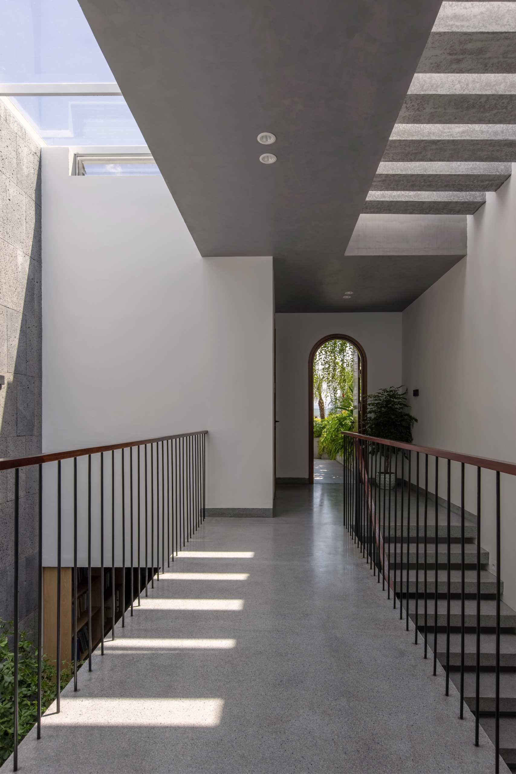 A modern house with an interior bridge and skylights.