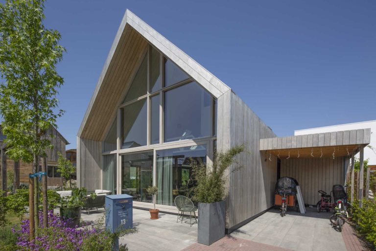 This Barn-Inspired Home Hides A Playroom With Climbing Wall Under Its Gable Roof