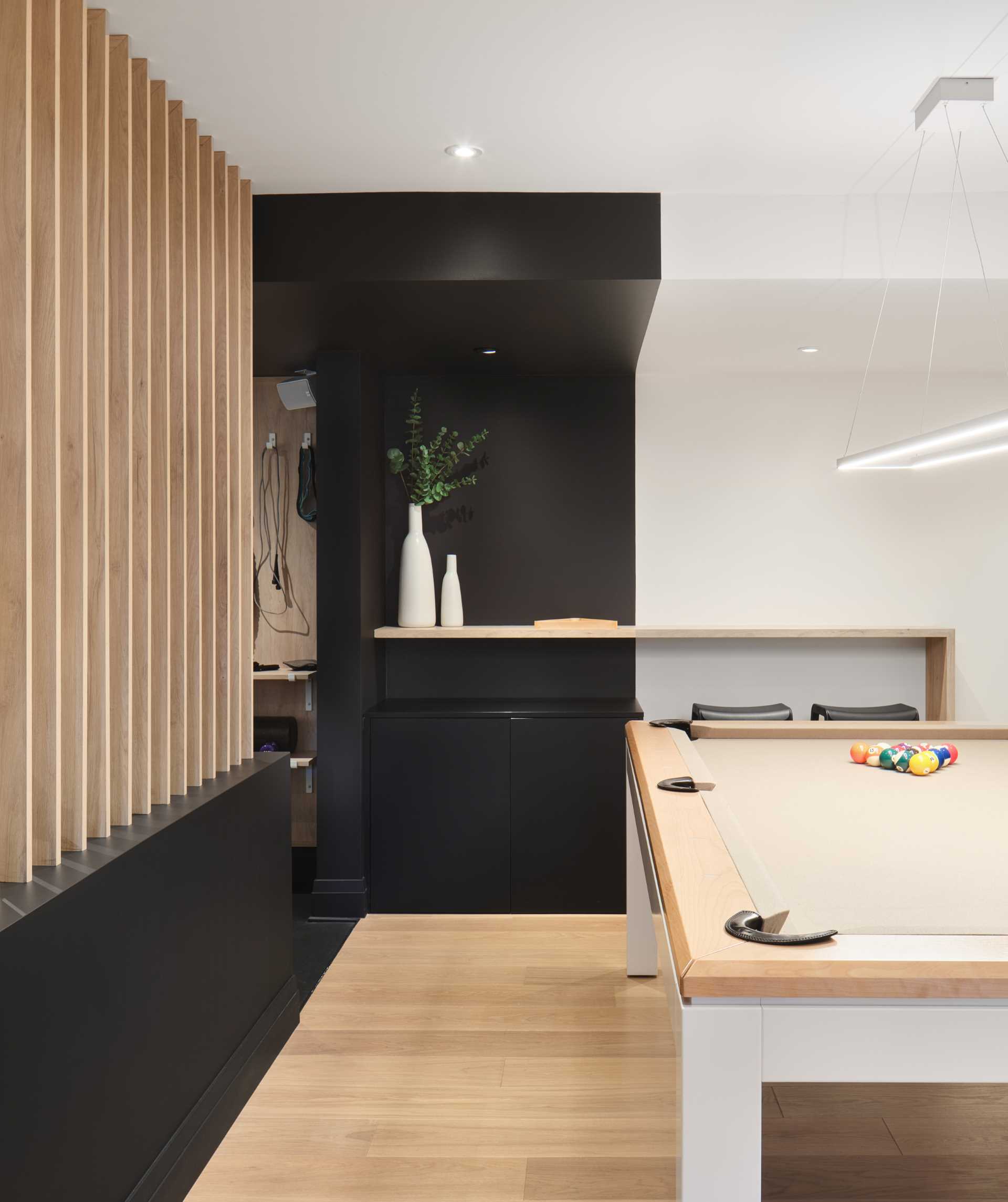 A modern basement with a games room.
