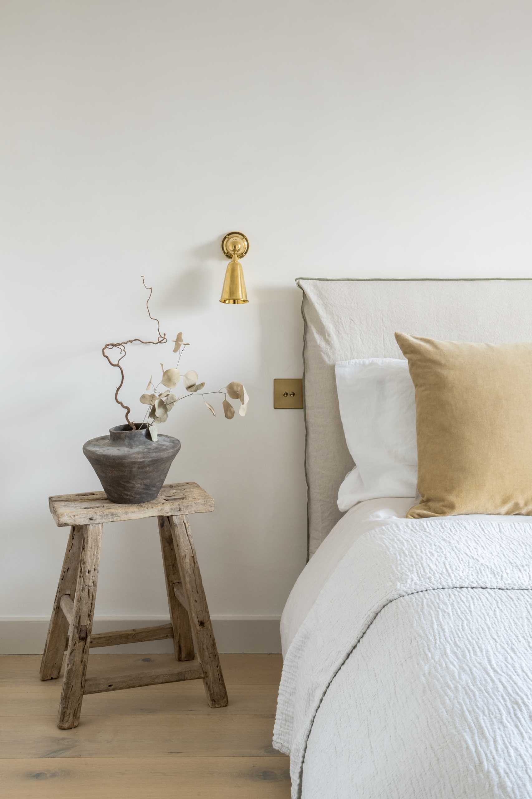 In this contemporary bedroom, there's a wood-lined window seat with storage below that overlooks the neighborhood.