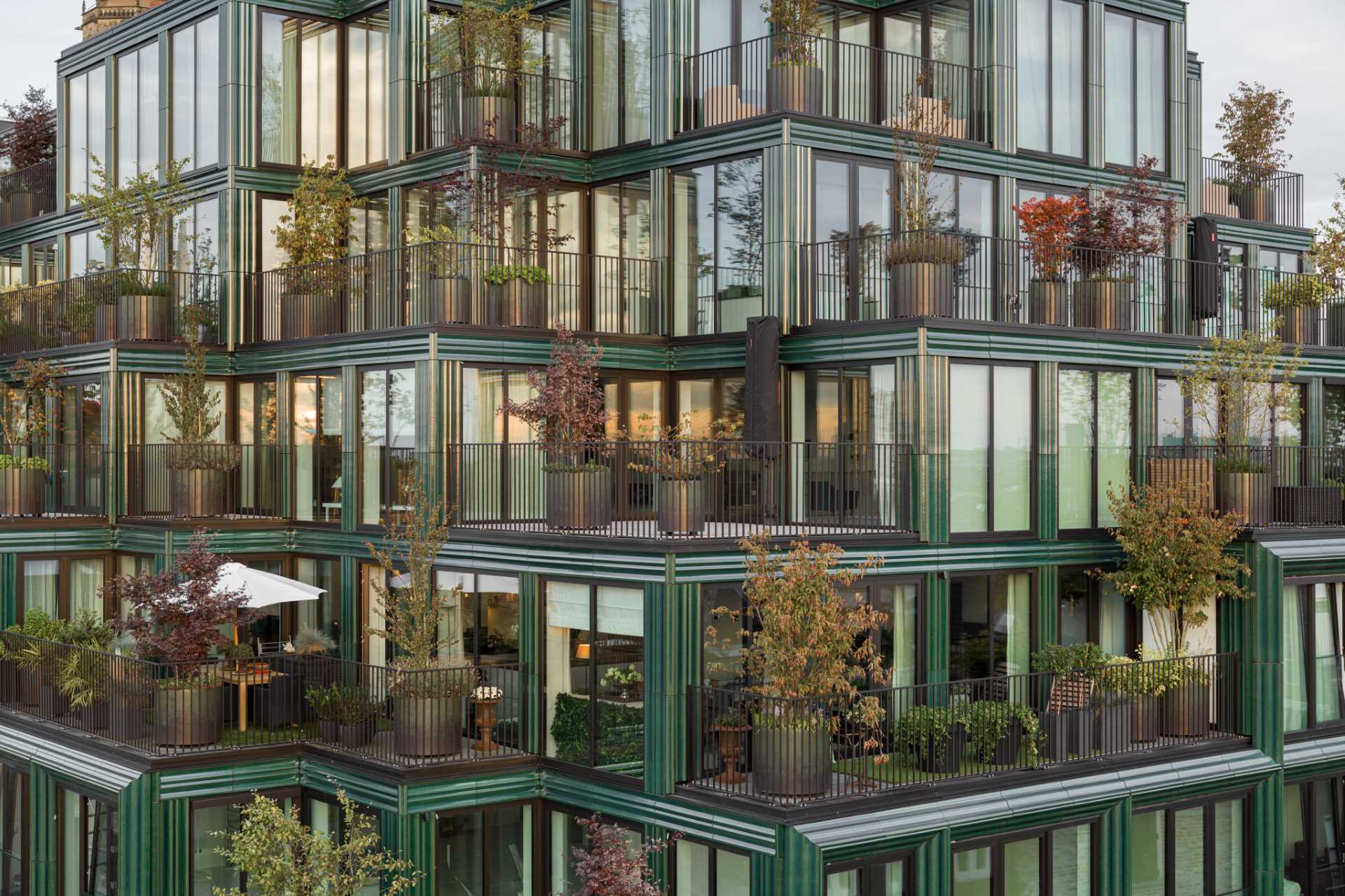 A modern building facade with glass and blue-green ceramic details.