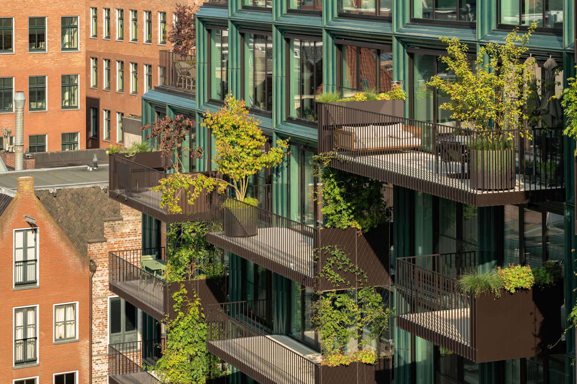 A modern building facade with glass and blue-green ceramic details.