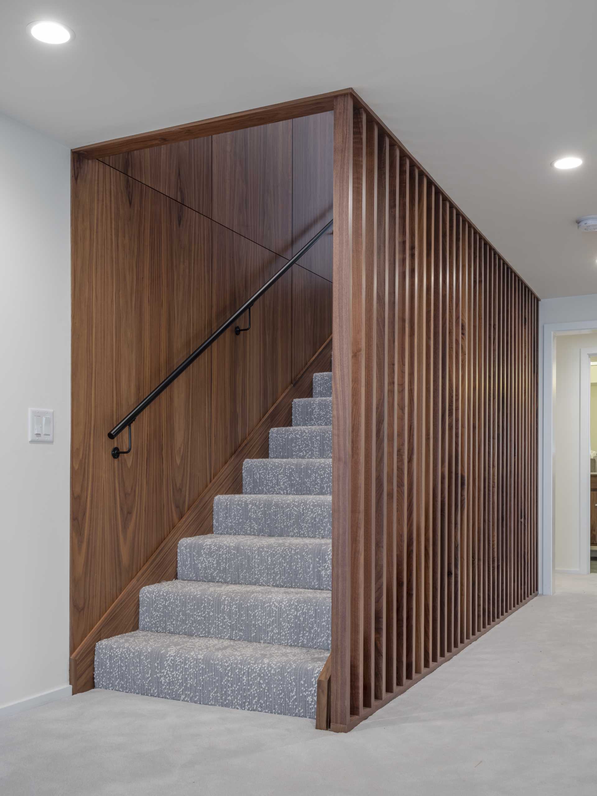Contemporary stairs with wood accent surround.
