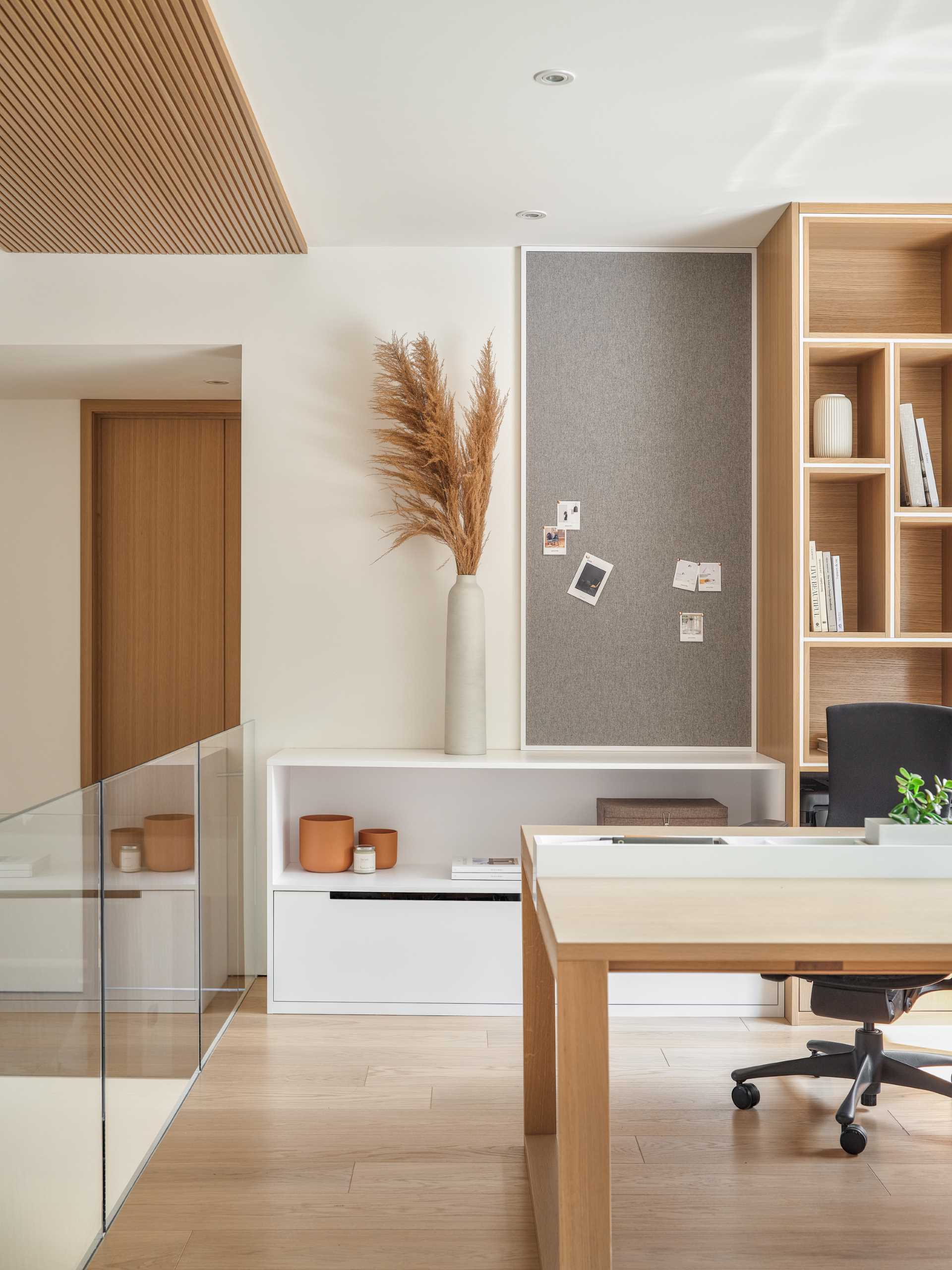 At the top of the stairs there's a home office, with built-in bookshelves and a desk.