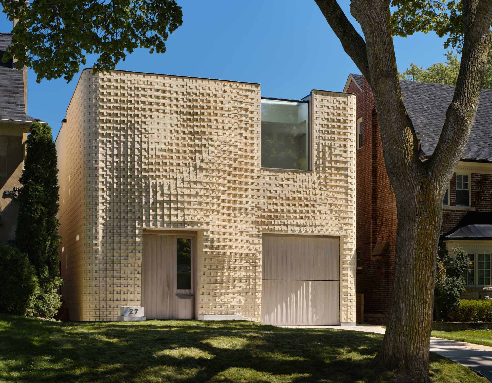 A sculptural brick facade for a single-family home in Toronto, Canada.