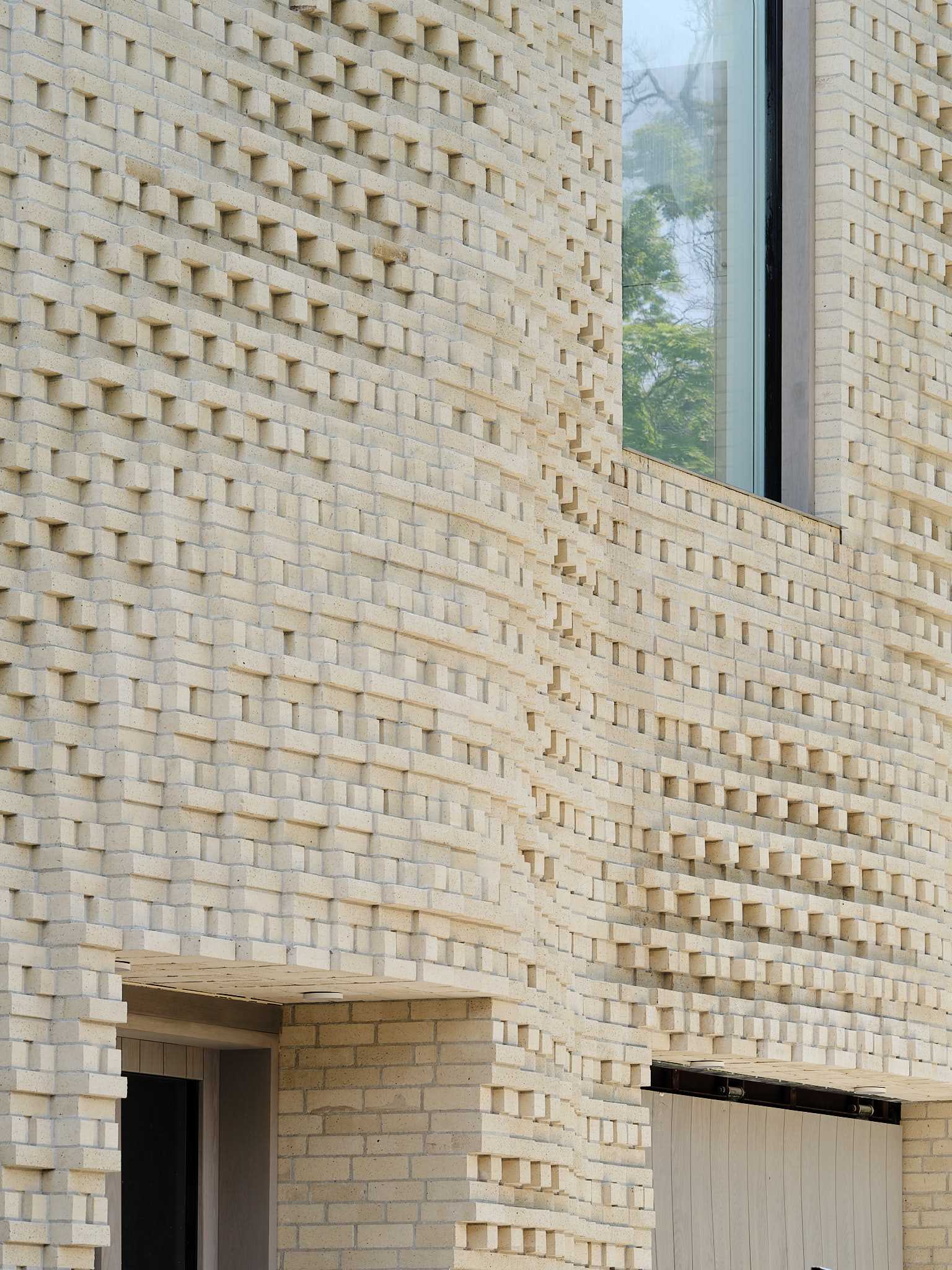 A sculptural brick facade for a single-family home in Toronto, Canada.