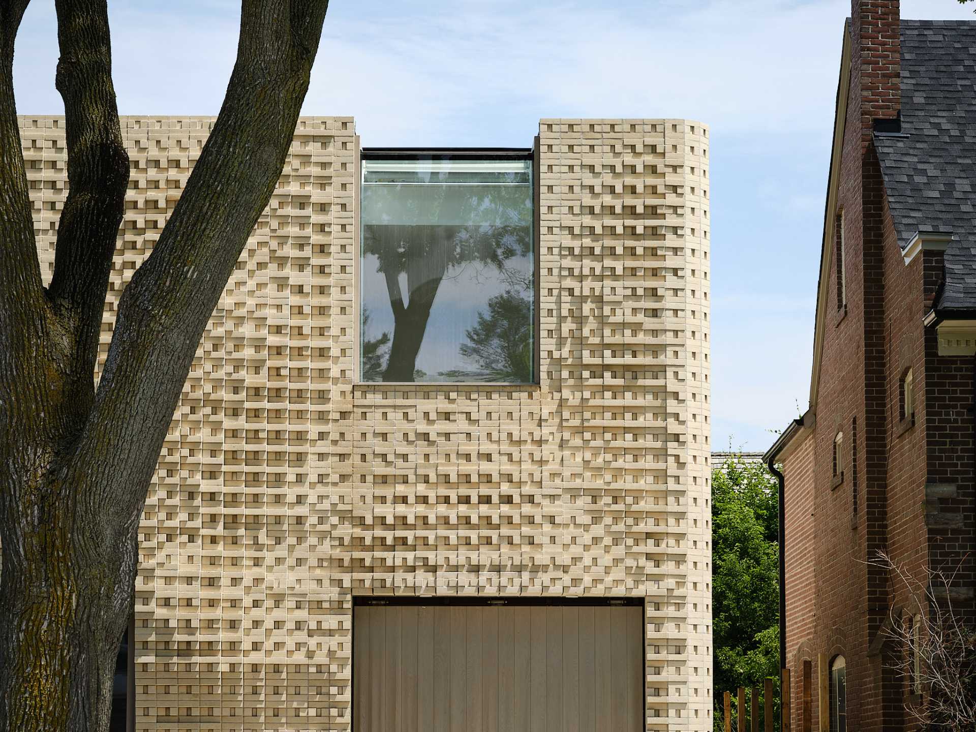 A sculptural brick facade for a single-family home in Toronto, Canada.