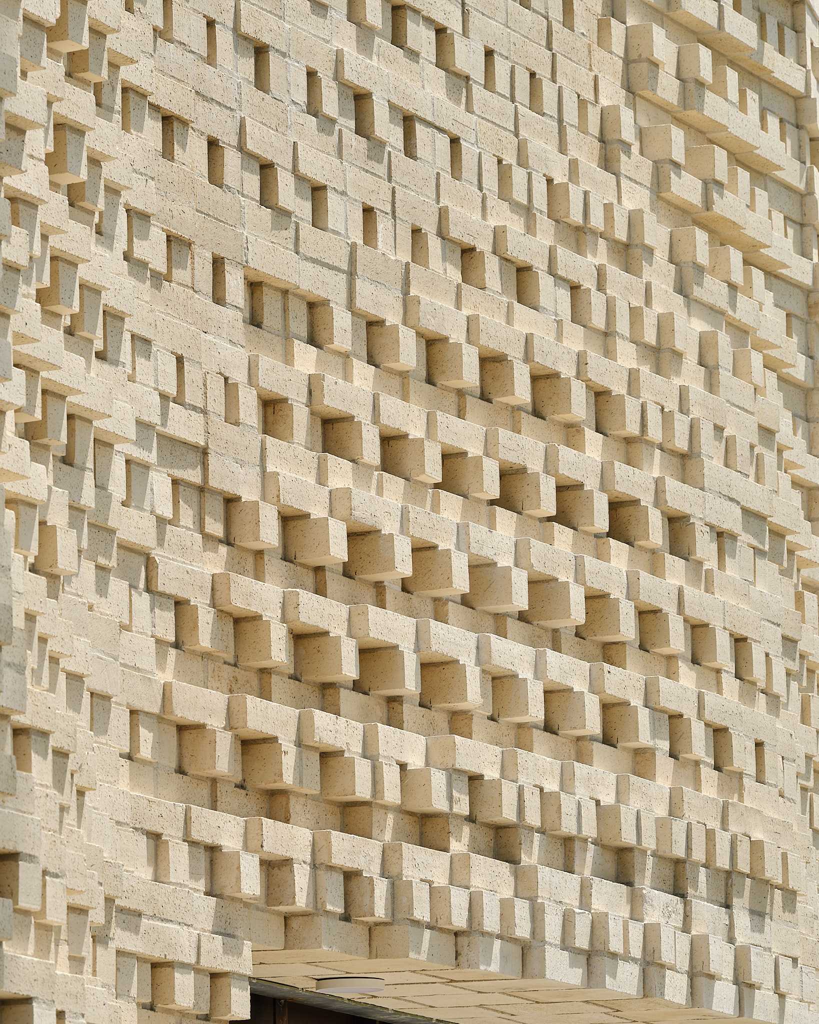 A sculptural brick facade for a single-family home in Toronto, Canada.