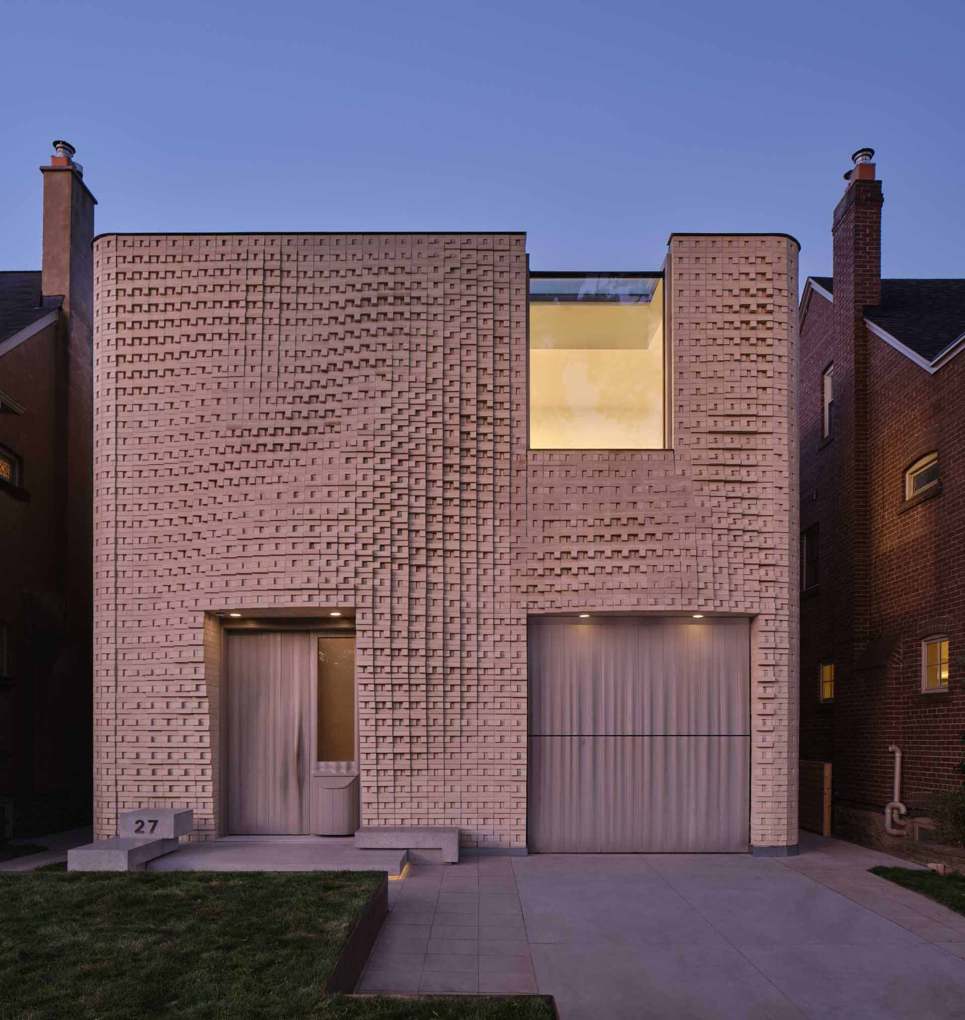 A sculptural brick facade for a single-family home in Toronto, Canada.