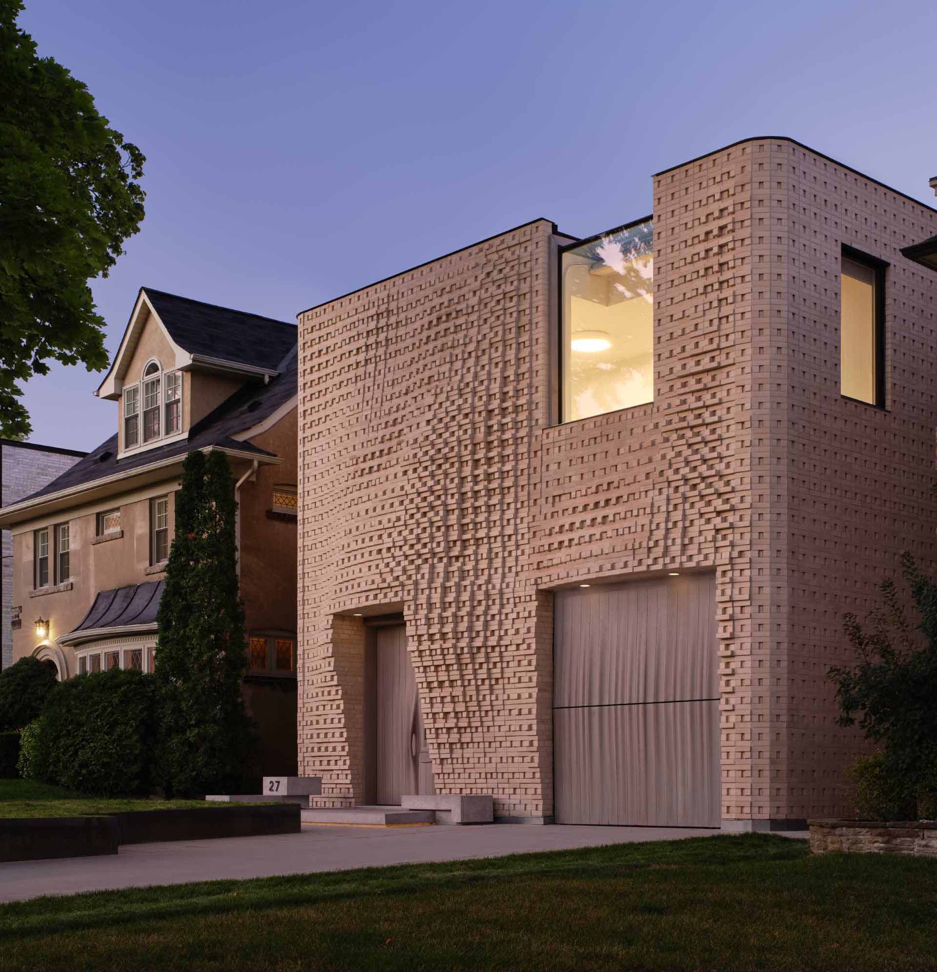 A sculptural brick facade for a single-family home in Toronto, Canada.