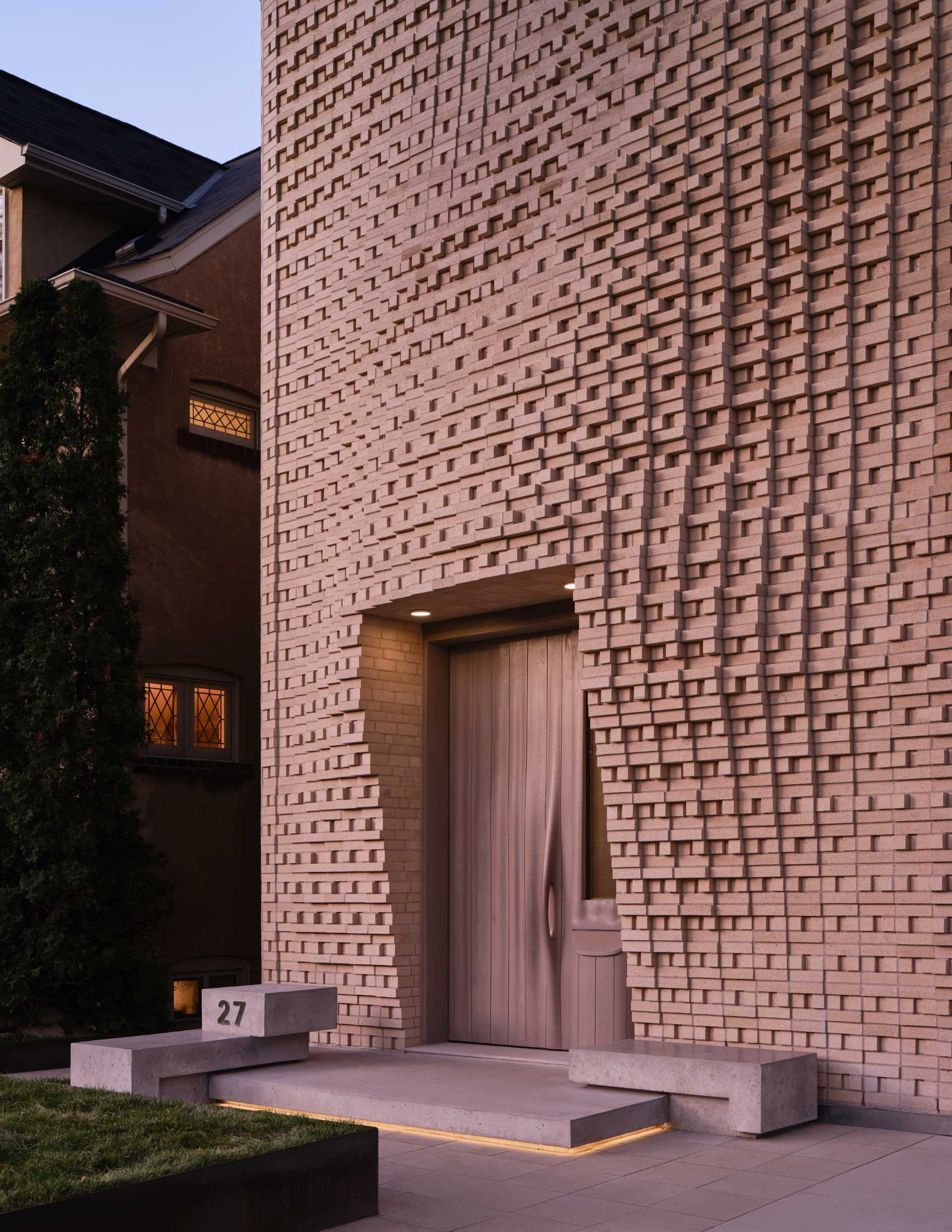 A sculptural brick facade for a single-family home in Toronto, Canada.