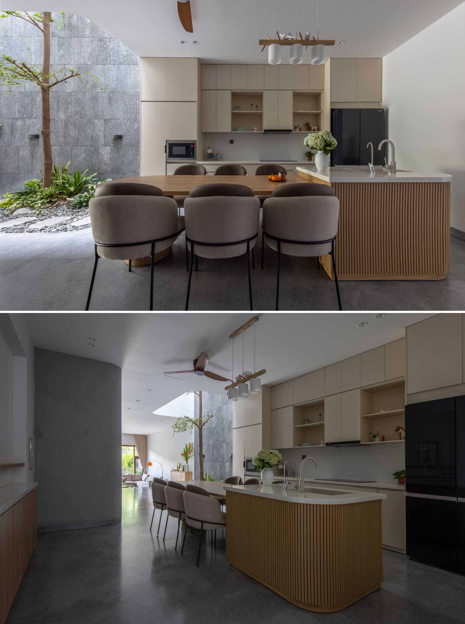 In this modern ،me interior, the dining area and the kitchen are combined, with the dining table integrated into the island.