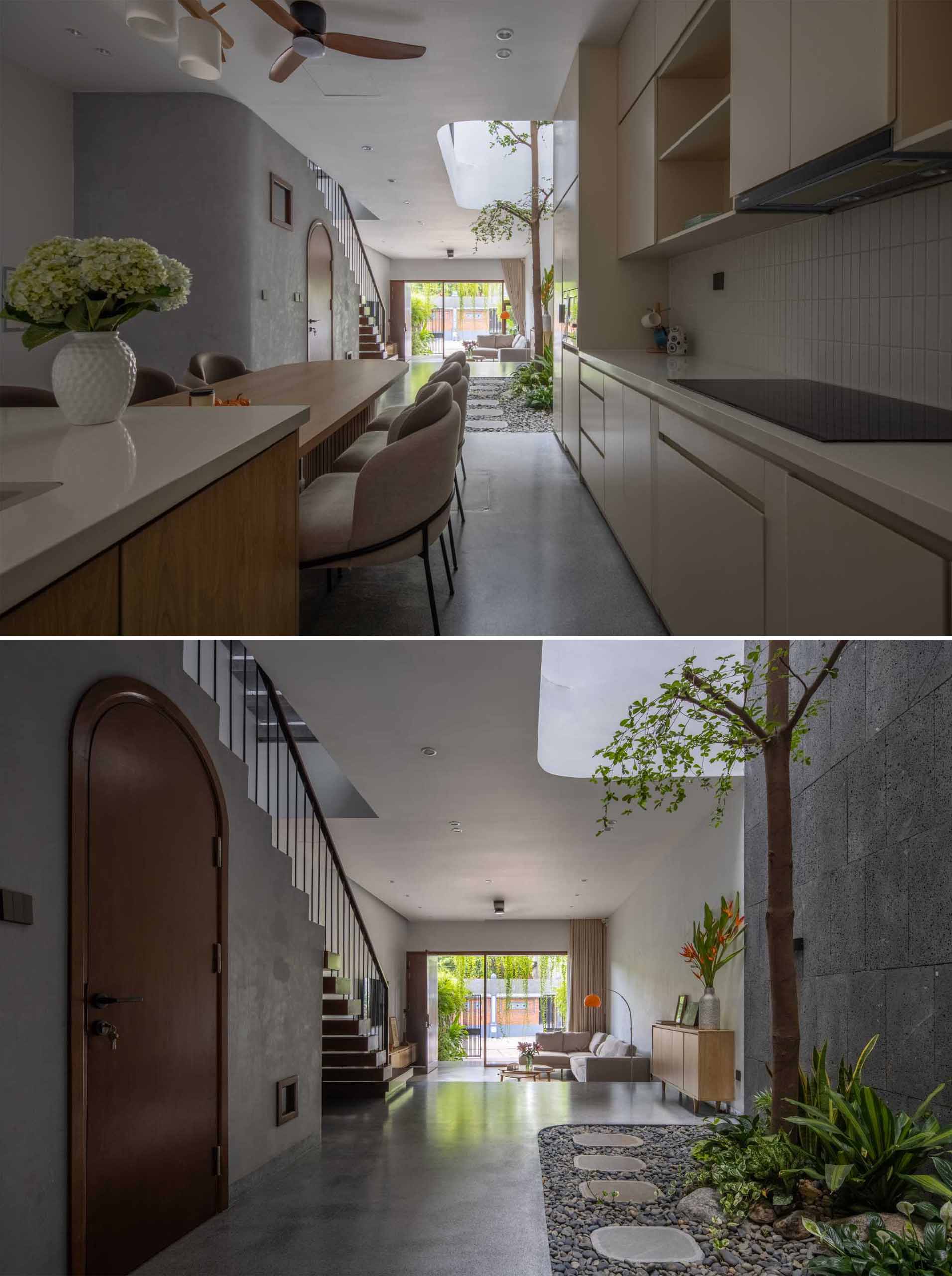 In this modern home interior, the dining area and the kitchen are combined, with the dining table integrated into the island.