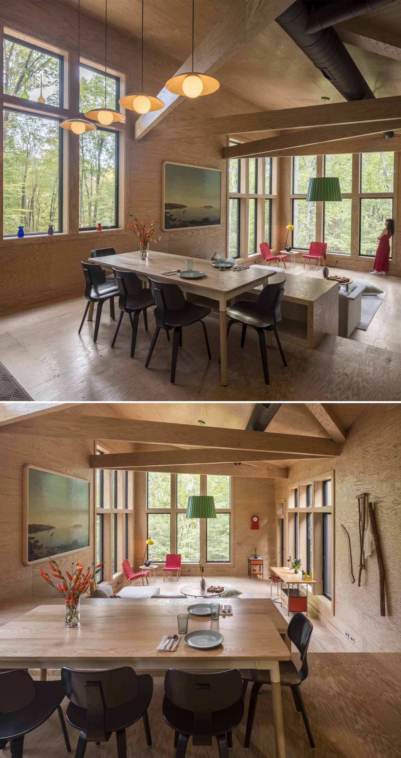 This dining area, which is located on a different level than the living room, is furnished with a wood table and black chairs, and separates the kitchen and living space.