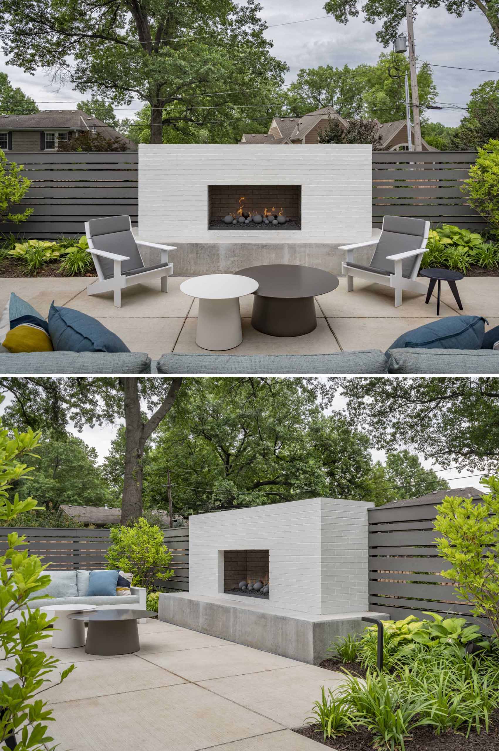 An patio furnished with plants, an outdoor lounge, and a fireplace.