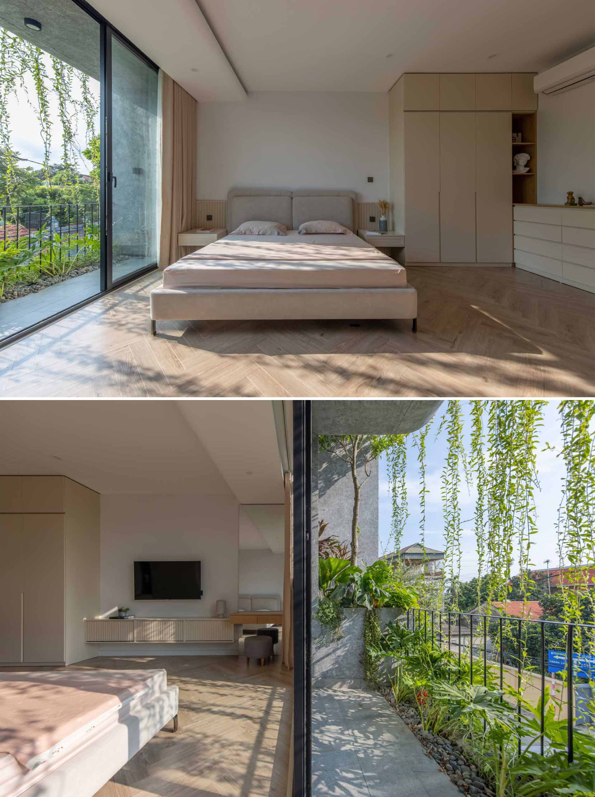 This primary bedroom has a neutral color palette, with floating bedside tables, closets, a dresser, and a vanity area. A sliding door connects the bedroom to a balcony with built-in planters.