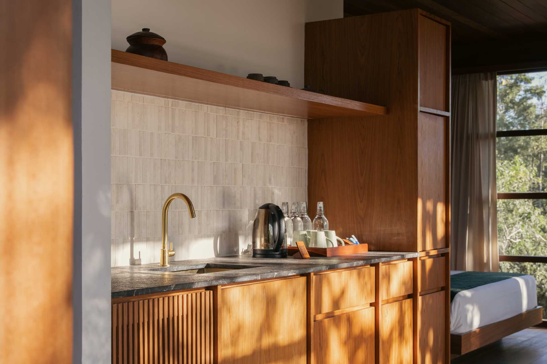 A modern kitchenette with wood cabinetry.