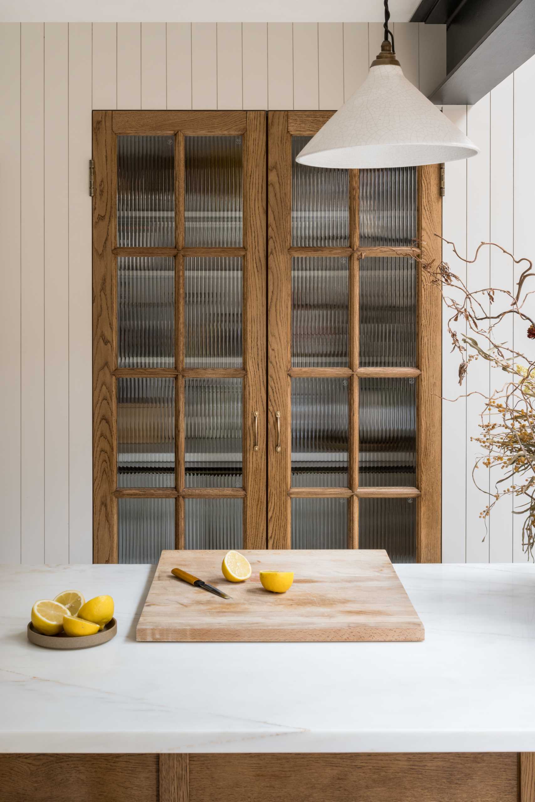 The pantry is considered the hub of the kitchen, with deep walnut framed doors hiding the shelving and storage when not in use.