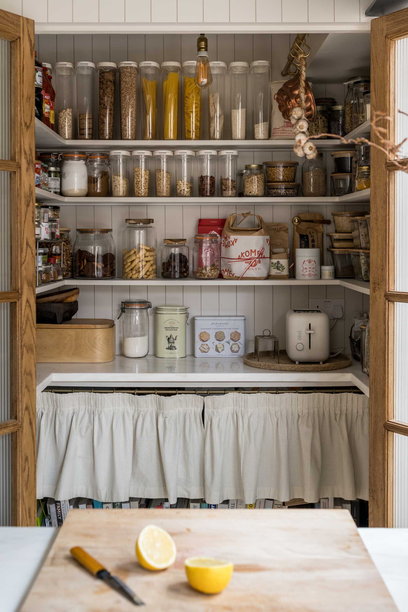 The pantry is considered the hub of the kitchen, with deep walnut framed doors hiding the shelving and storage when not in use.