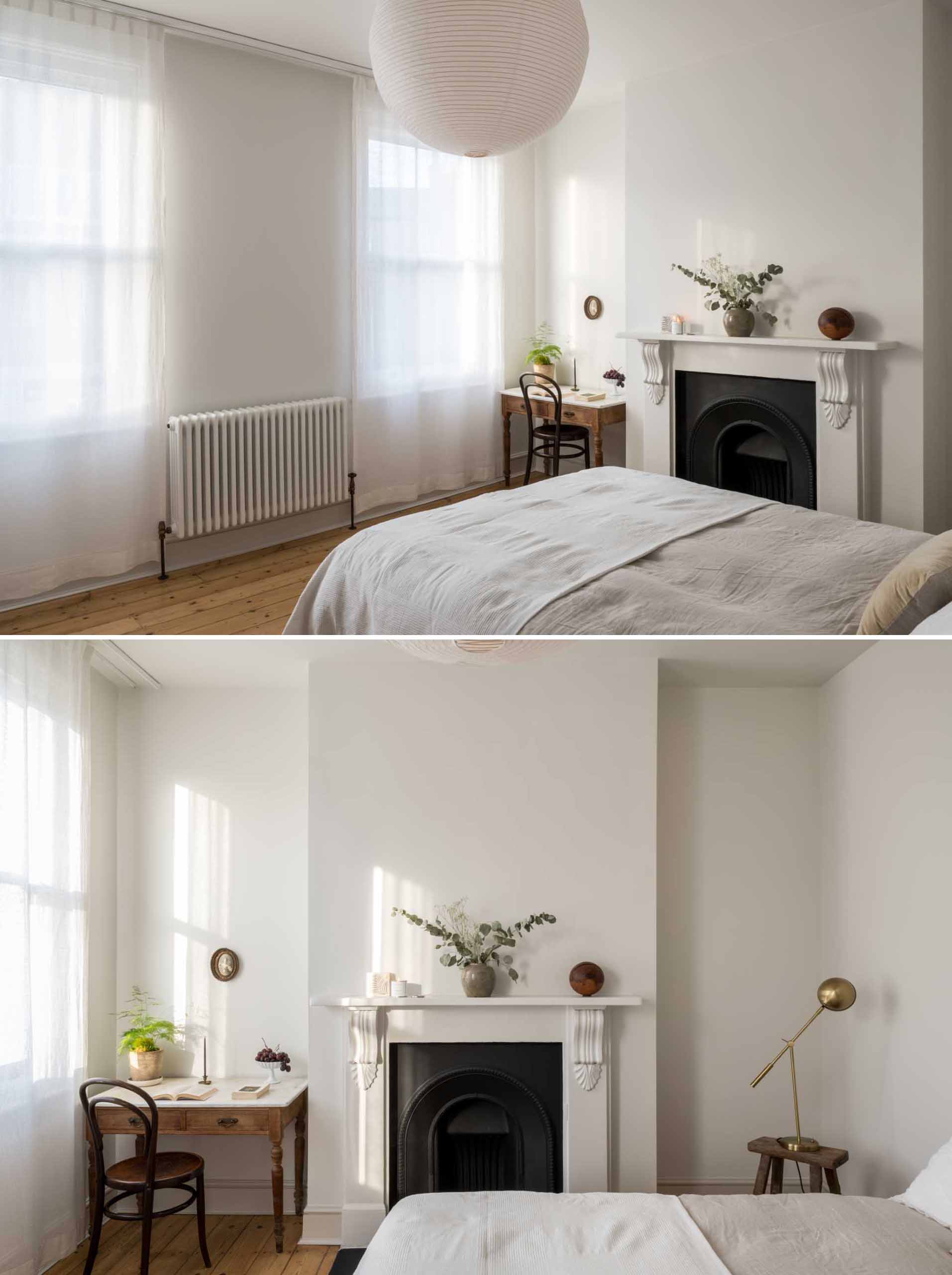 A renovated bedroom retained original elements, like the fireplace.