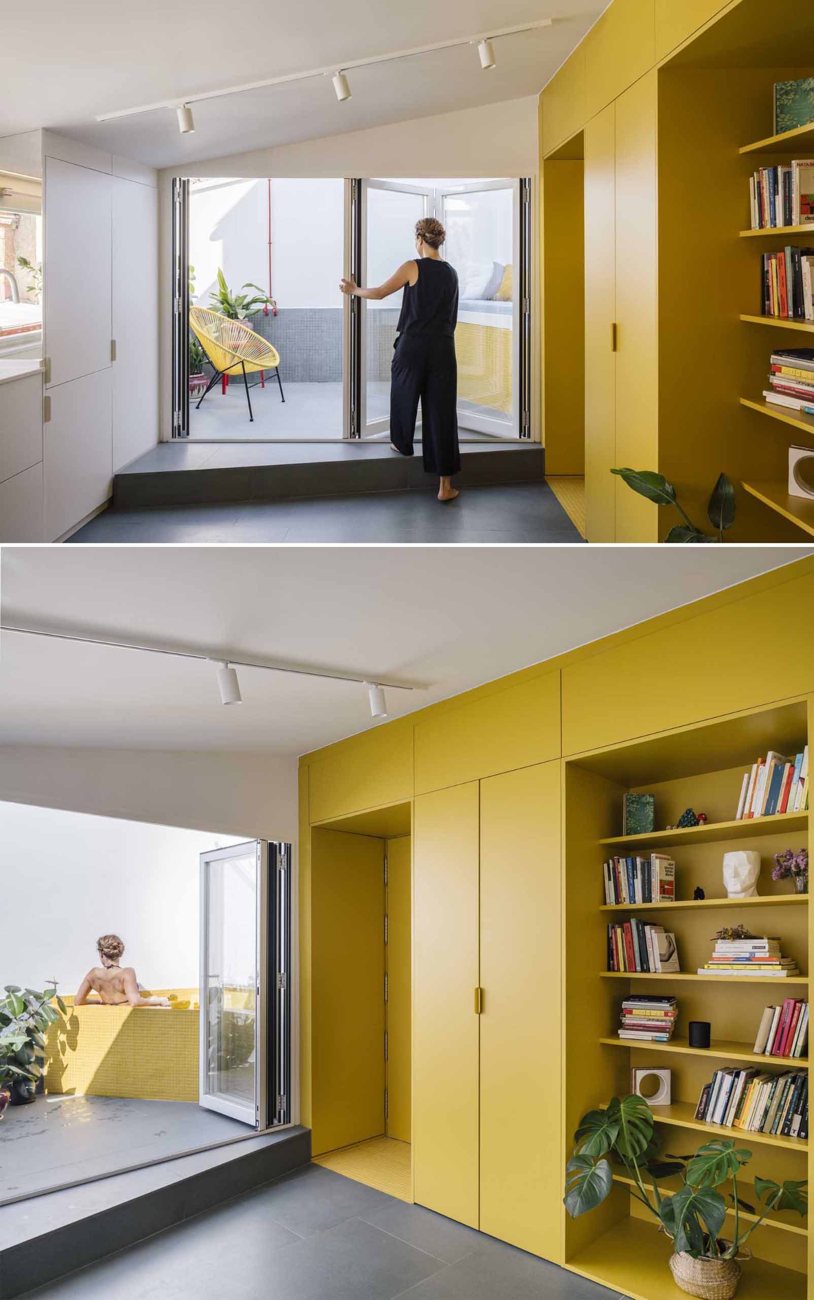 A small apartment with a yellow accent wall has folding doors that open to a small terrace with an outdoor shower, and a daybed that hides an outdoor bathtub underneath.